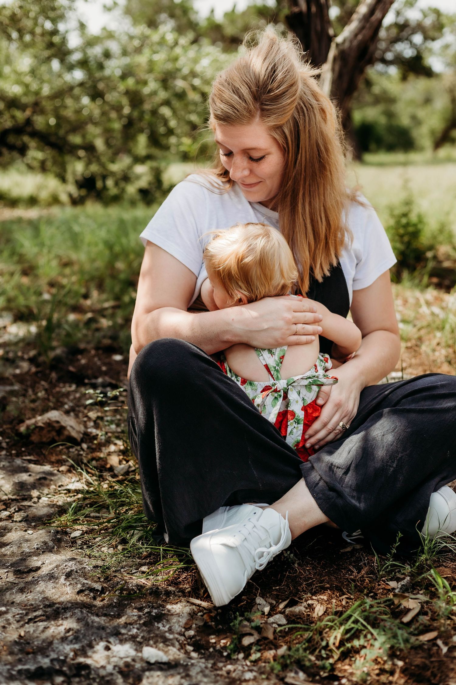 mother nurses toddle while she sits on her moms lap