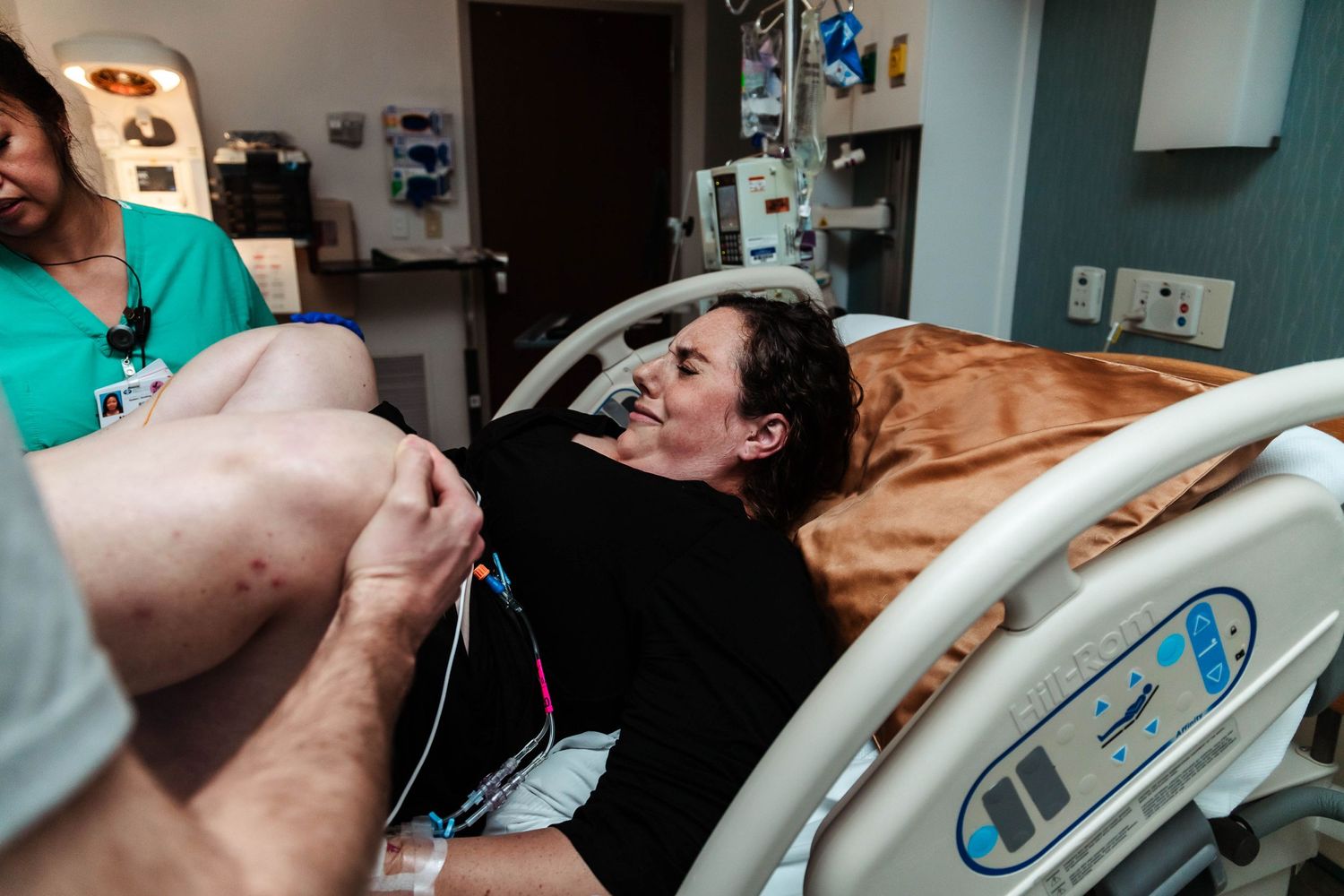 Laboring mother bears down to push her baby out