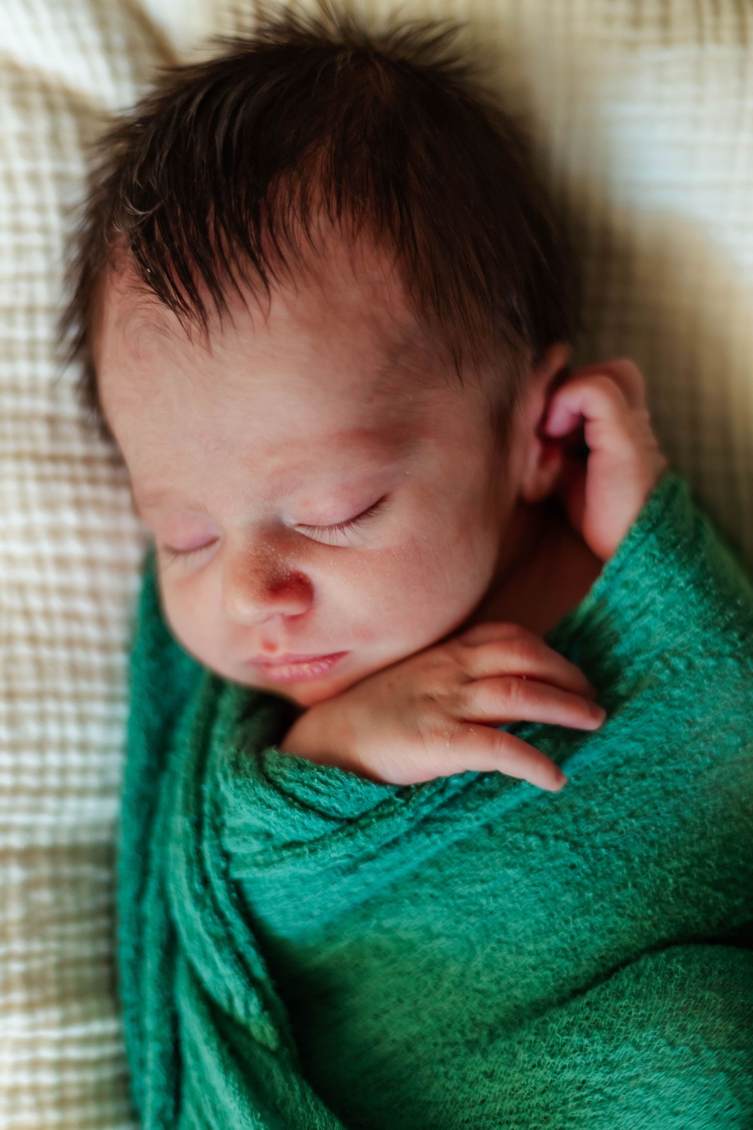 Newborn baby boy wrapped up for newborn session