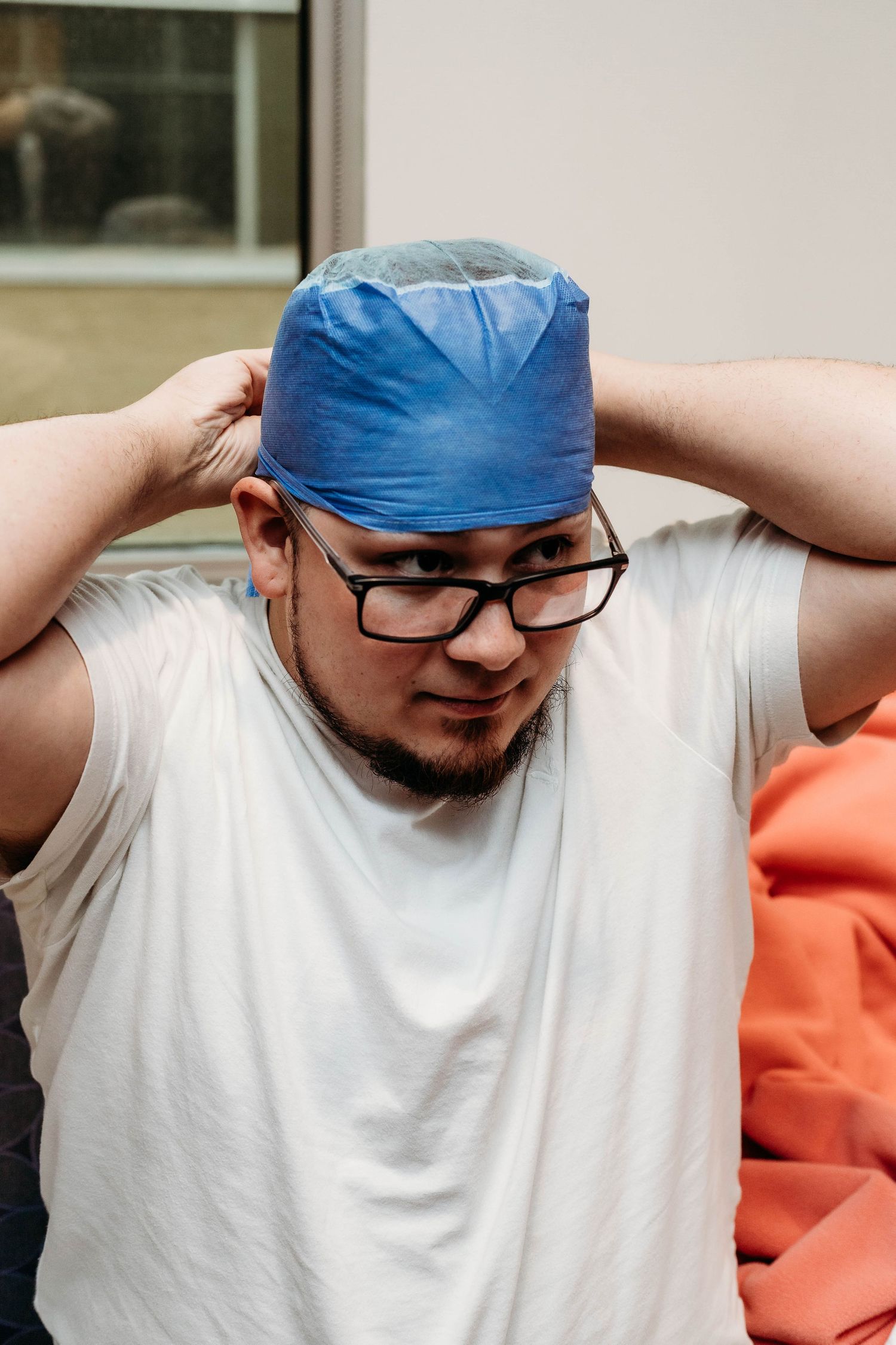 Husband gets dressed in OR gear for Wife's caesarean