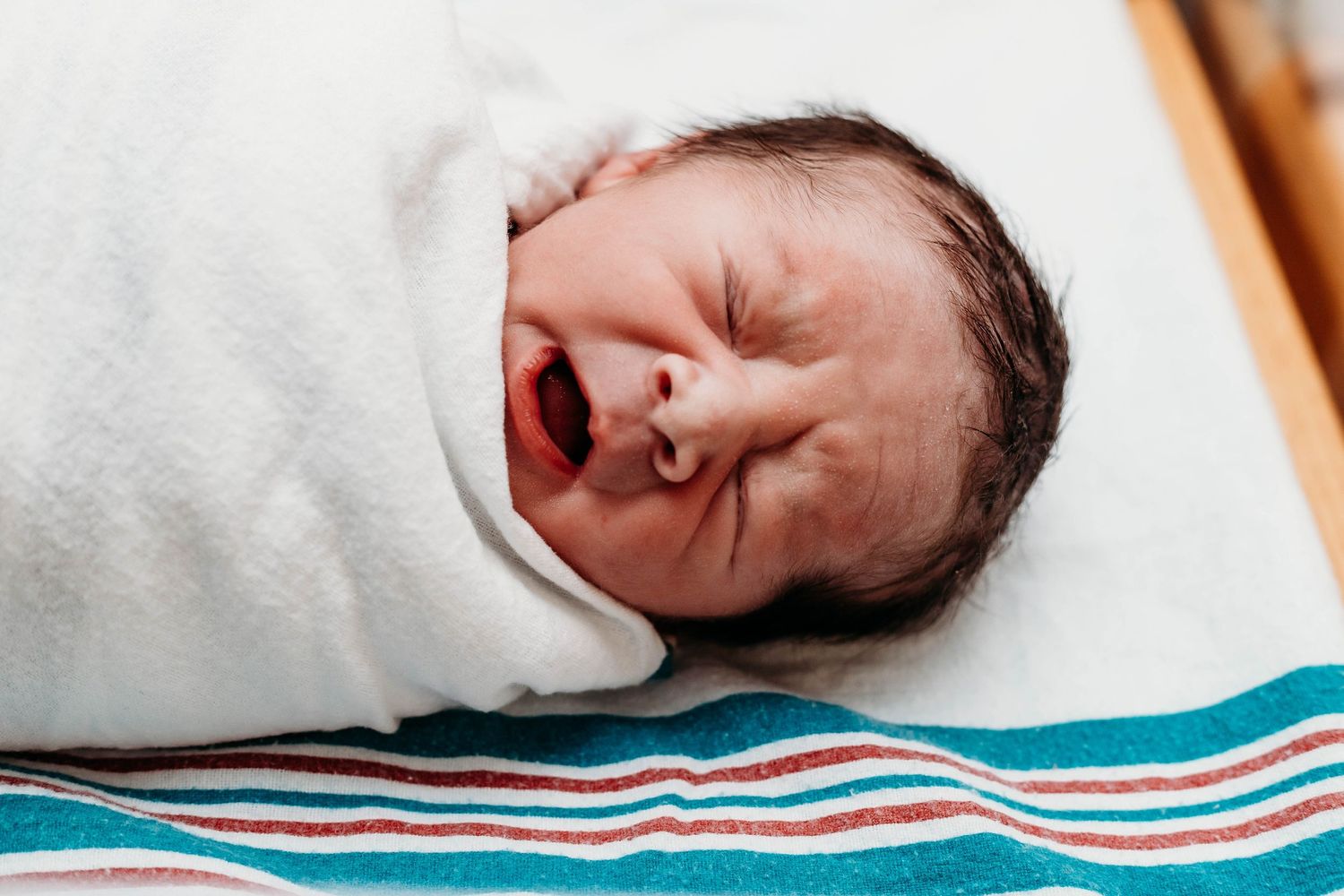 New born baby yawns in hospital