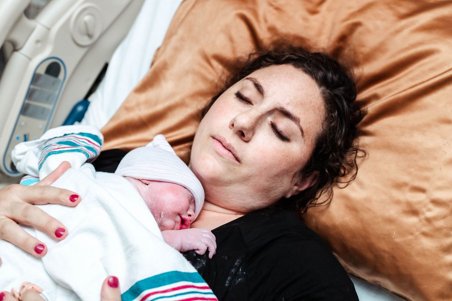 Mother holds baby peacefully after delivery