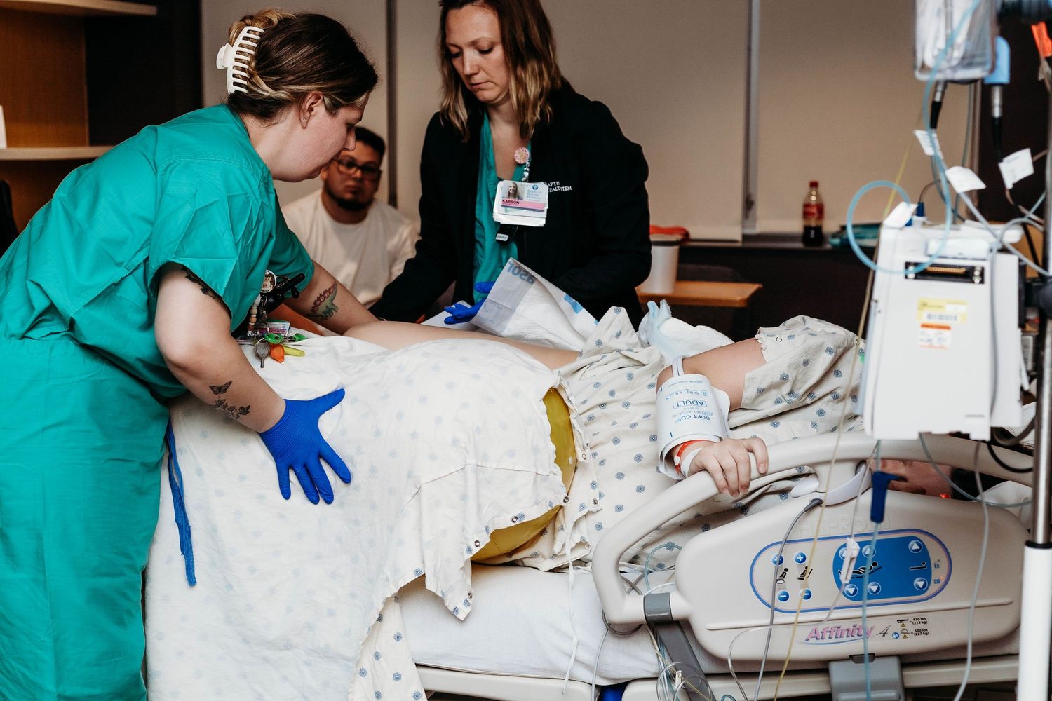 Nurses help placing laboring mother into the flying cowgirl spinning babies position