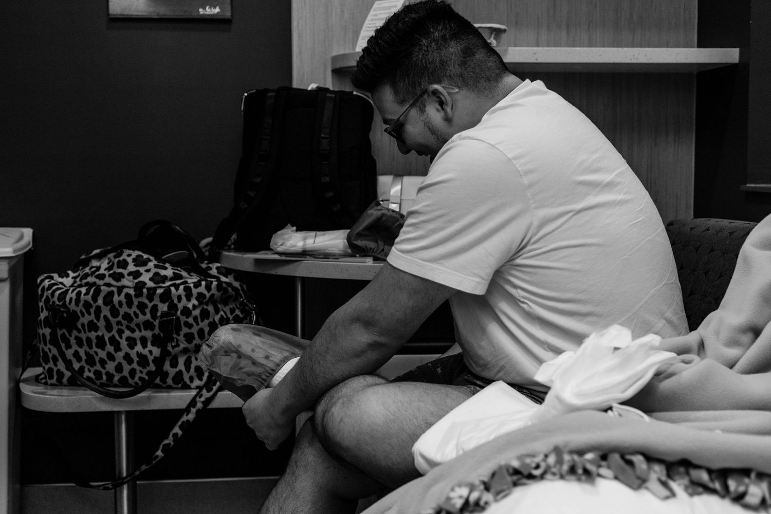 Husband puts on covers for his shoes before cesarean