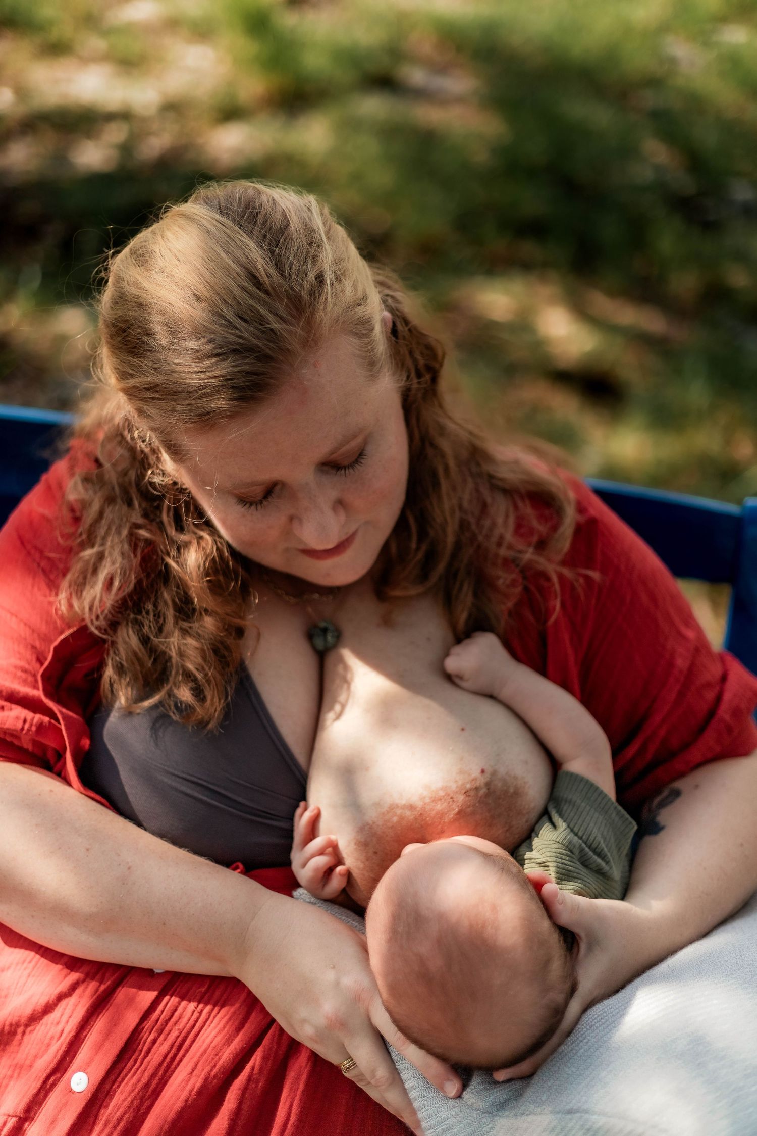 mother uses pillow to help nurse baby