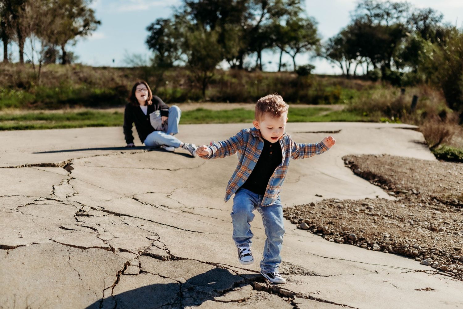 Little boy runs towards camera while the older sister yells at him to watch where he's going