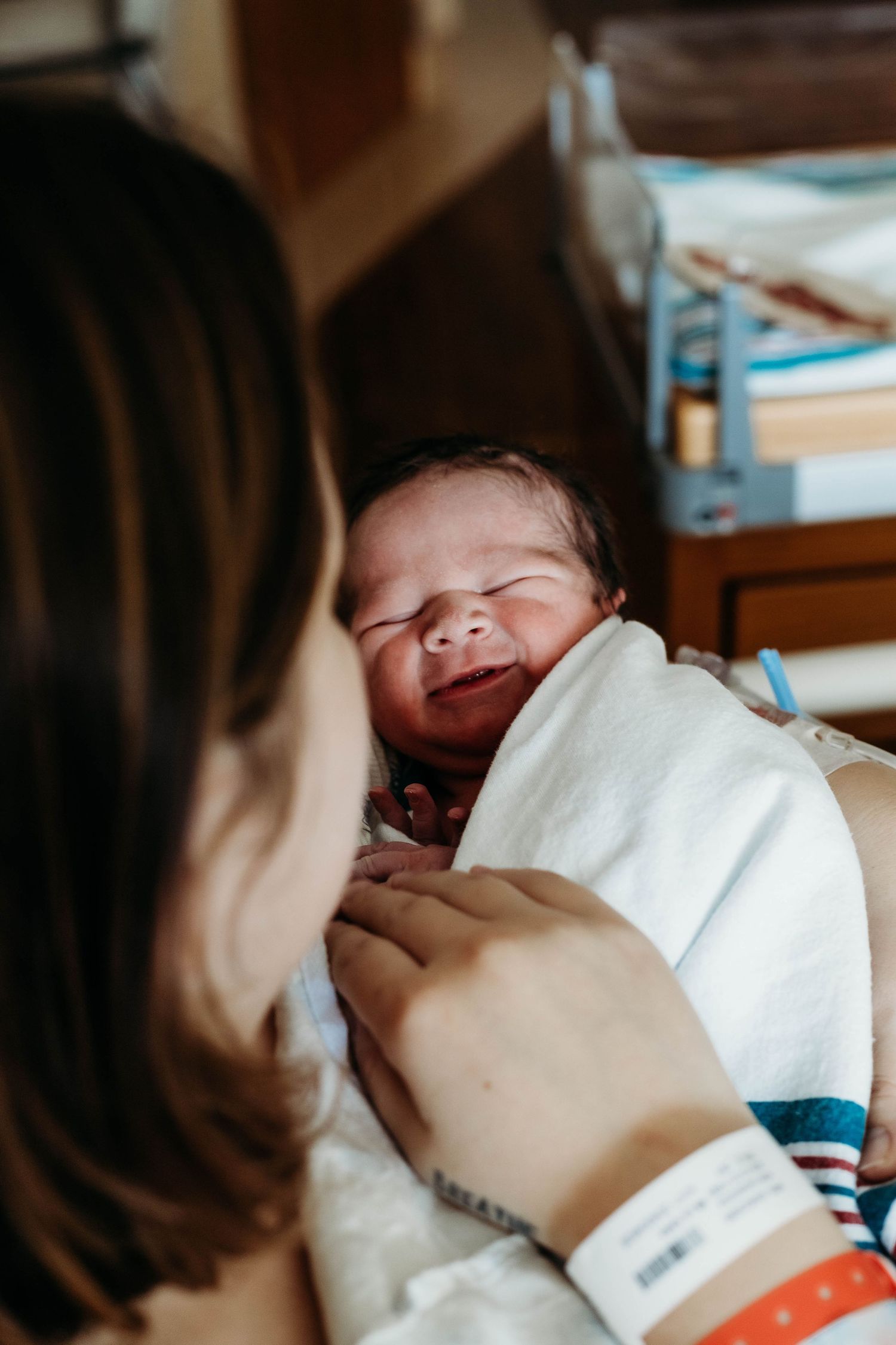 Mother looks at her new born baby in hospital.
