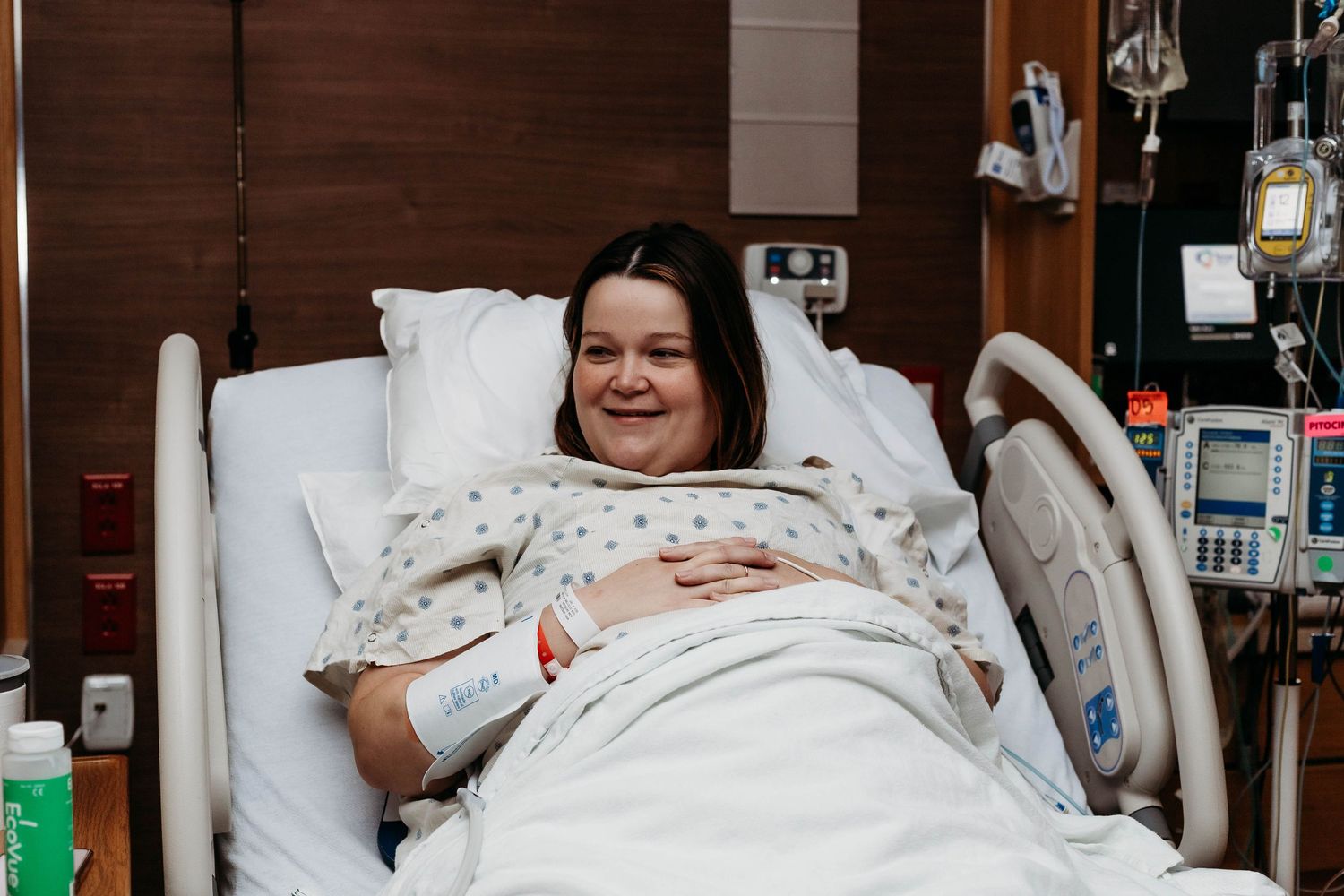 Laboring mother talking with her husband, smiling and in good spirits.
