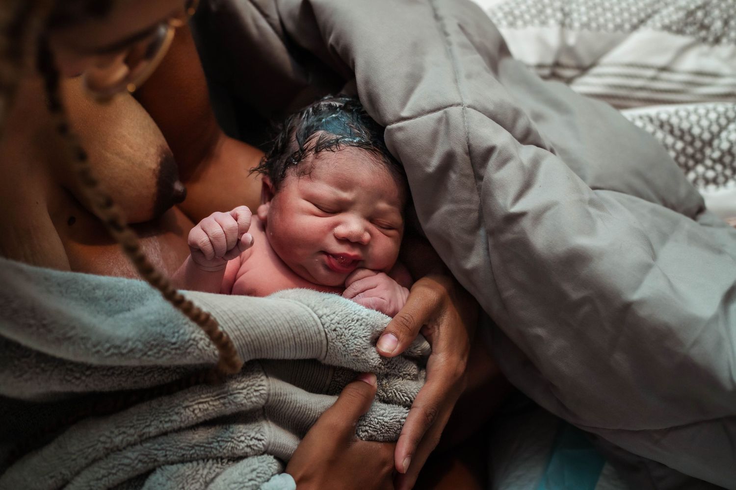 Mother holding baby wrapped in towek
