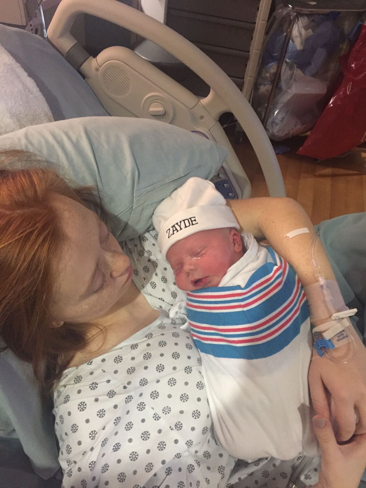 Mother, Morgan of MZiegler Imagery & Doula Services, holds her baby after delivery in hospital