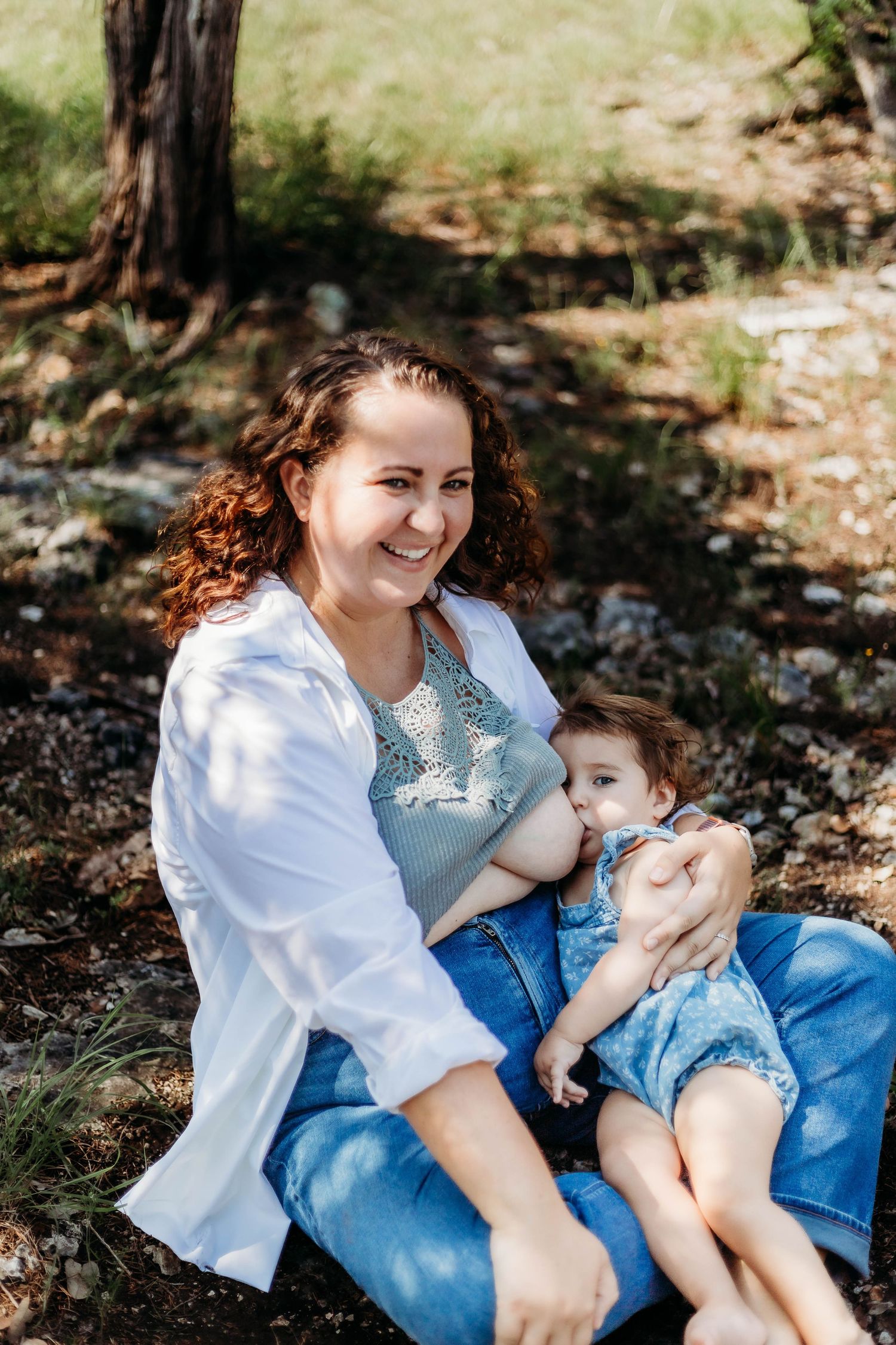 mother breastfeeds baby outside