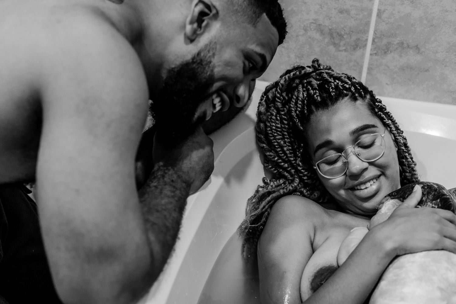 Mother and father look at newborn baby
