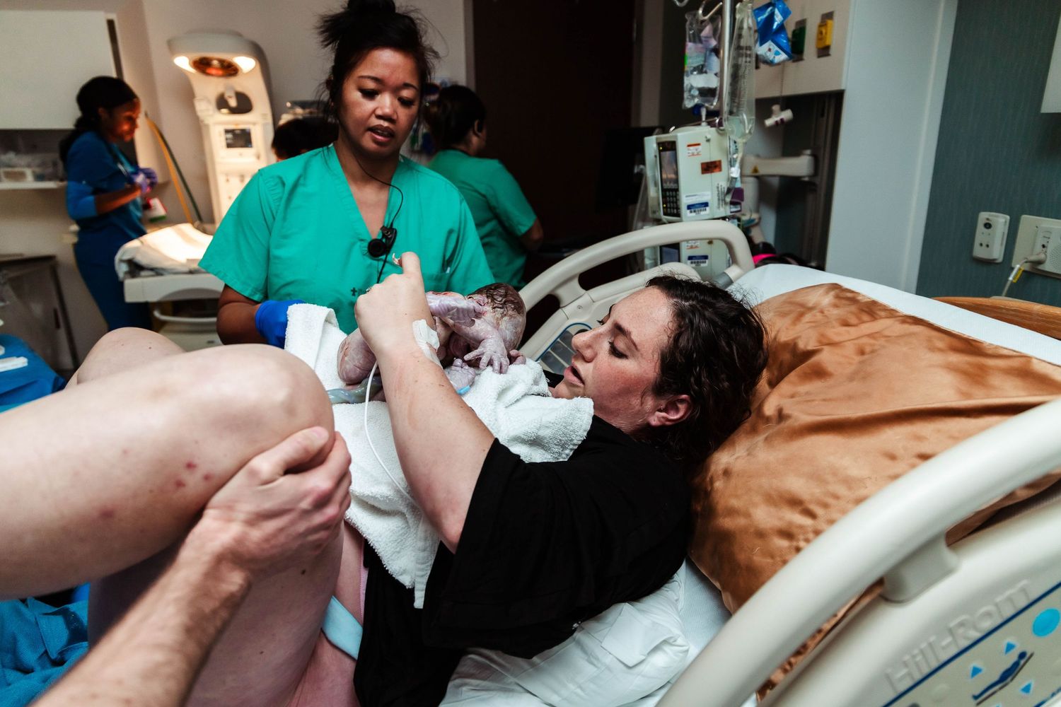 Mother checks newborn baby's sex, as they didn't know prior
