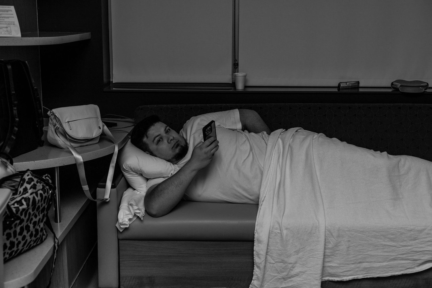 Father lays on couch in delivery room to sleep overnight