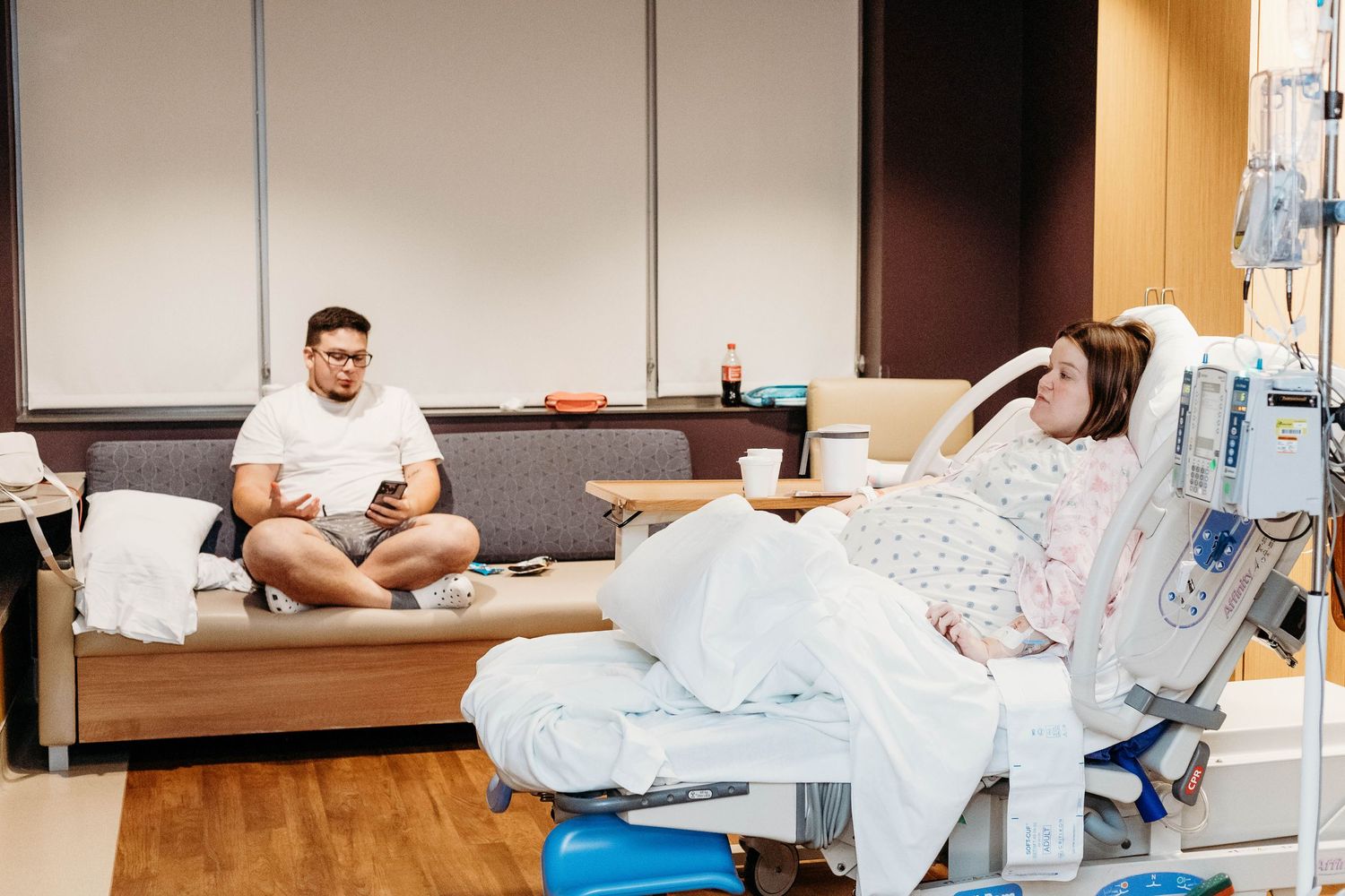 Husband and Wife sitting in delivery room waiting for labor to start