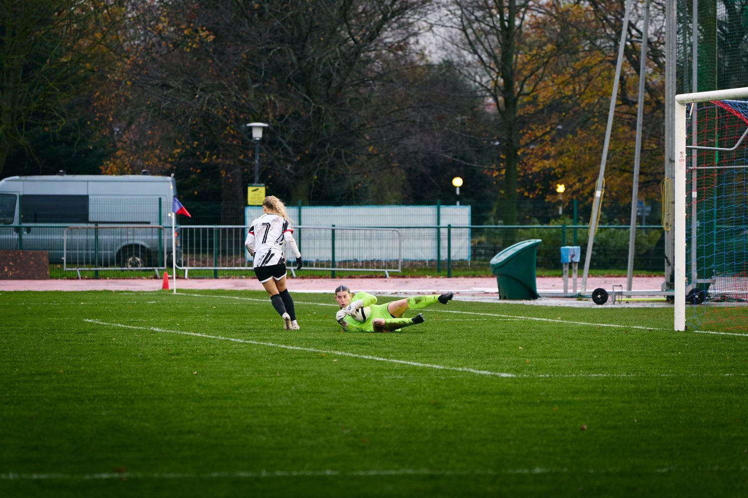 A series of action shots from a soccer match showing players competing near the goal on a grass field.