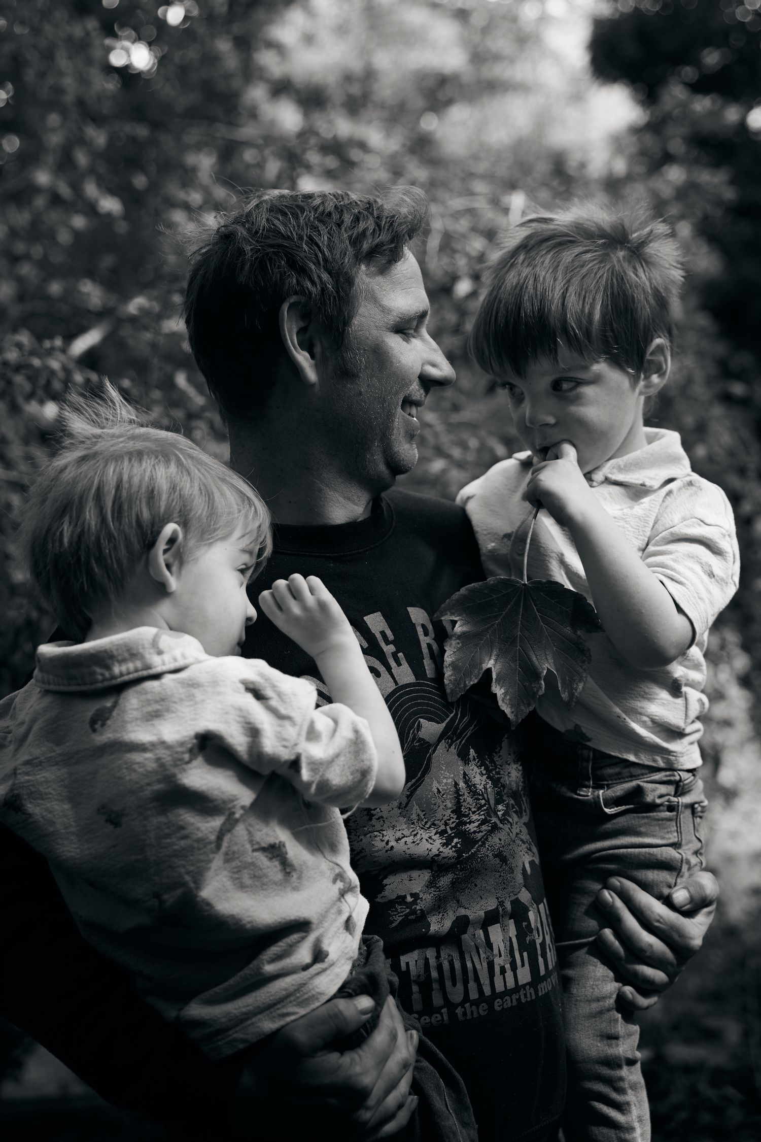 A series of black and white photos showing tender playful moments between a parent and child.