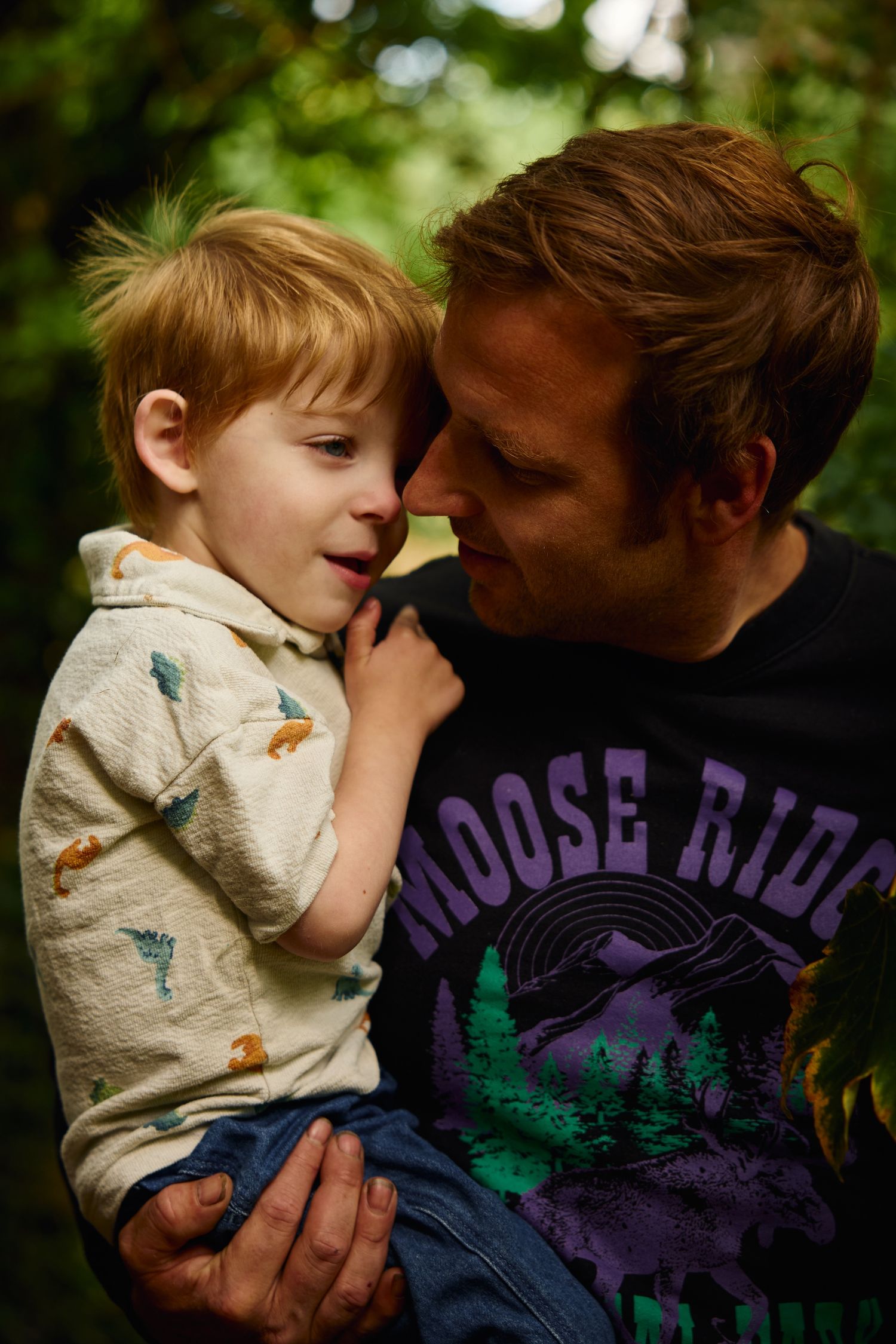 Intimate moments between parent and child captured in warm lighting against a natural background.