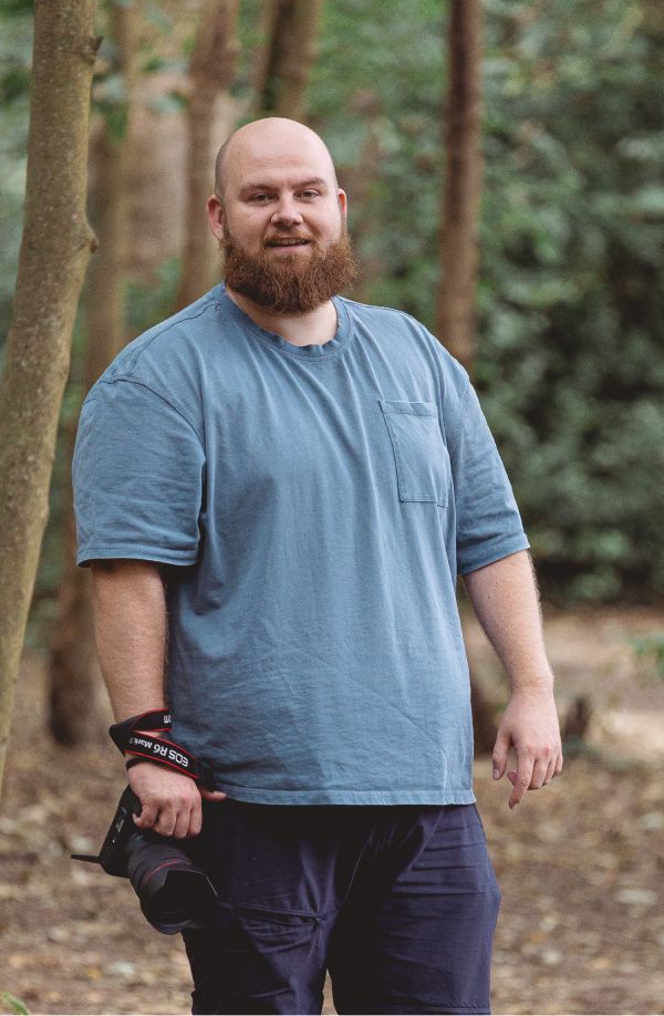 A series of outdoor portraits showing a person in a blue t-shirt and dark pants standing among trees.
