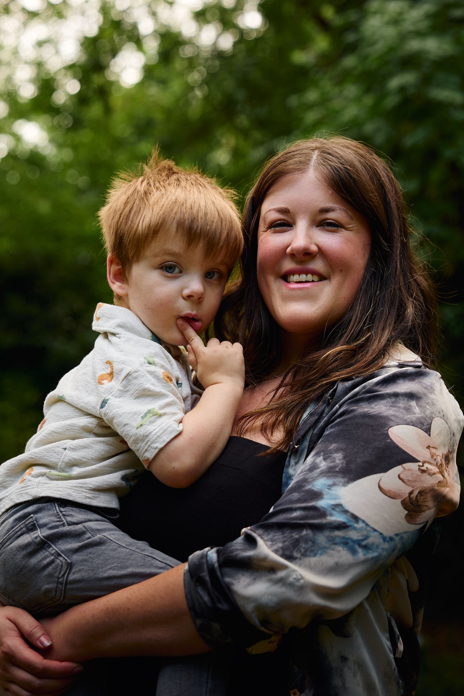 Candid outdoor family photos showing joyful embraces and laughter.