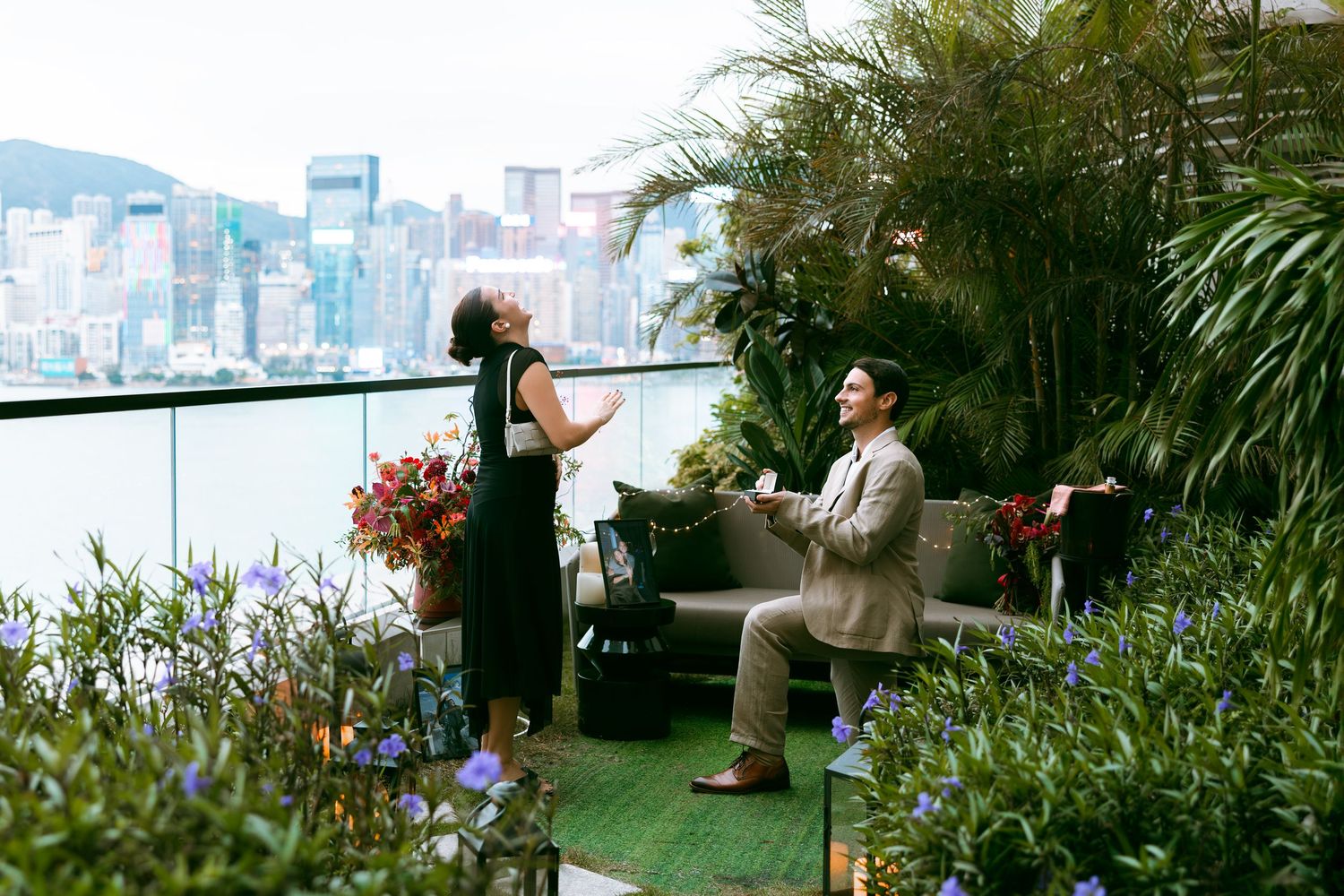 proposal in Rosewood Hong Kong.  on a lush rooftop terrace with Hong Kong skyline and Victoria Harbour in the background. Pre Wedding in HK