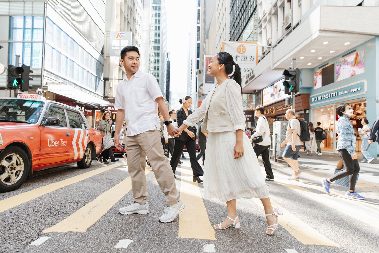 Couple  summer outfits walking down a busy urban street in Central. Couple Photoshoot in Central, Hong Kong