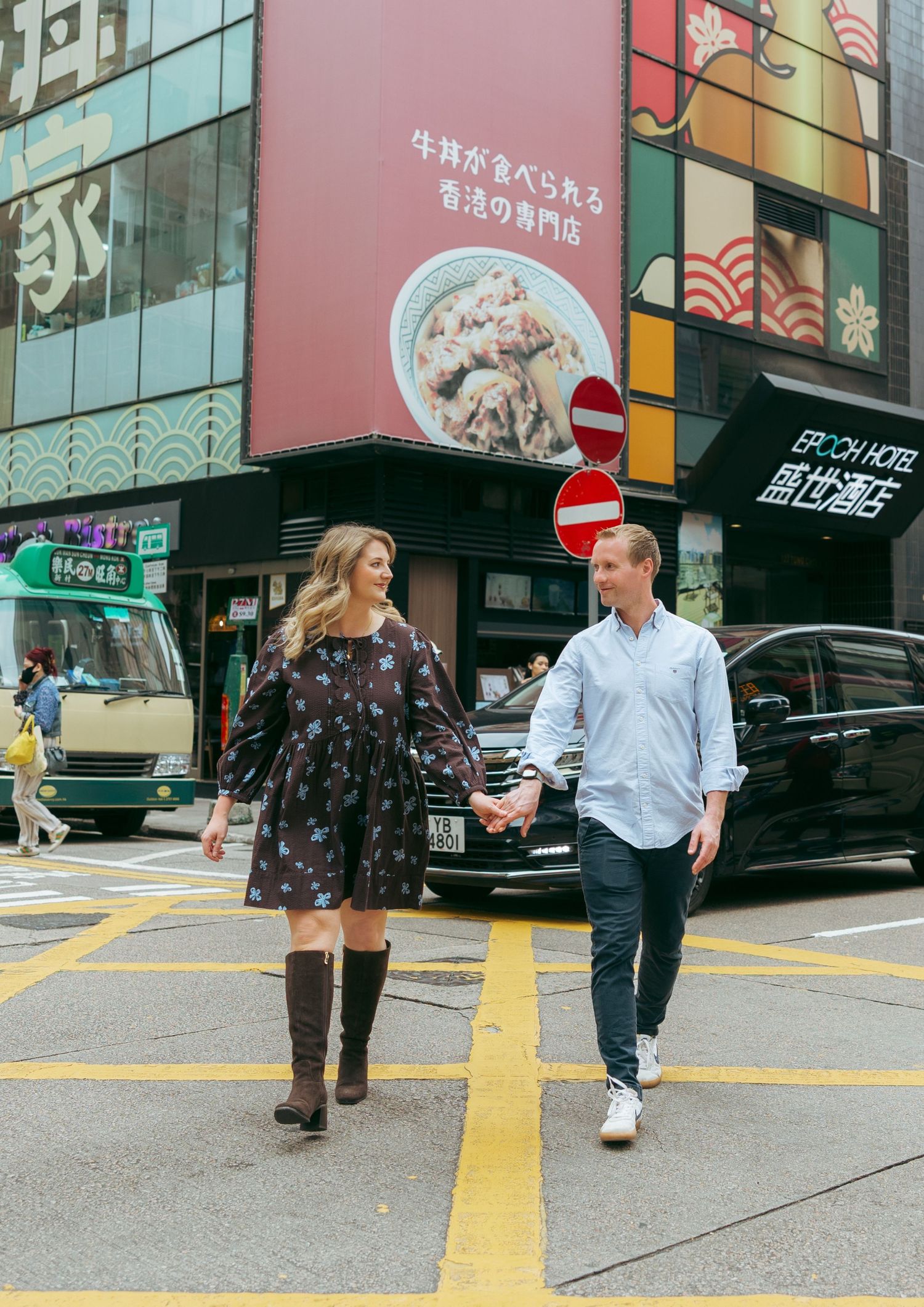Couple holding hands walking across a crosswalk couple session in Hong Kong. Pre Wedding HK