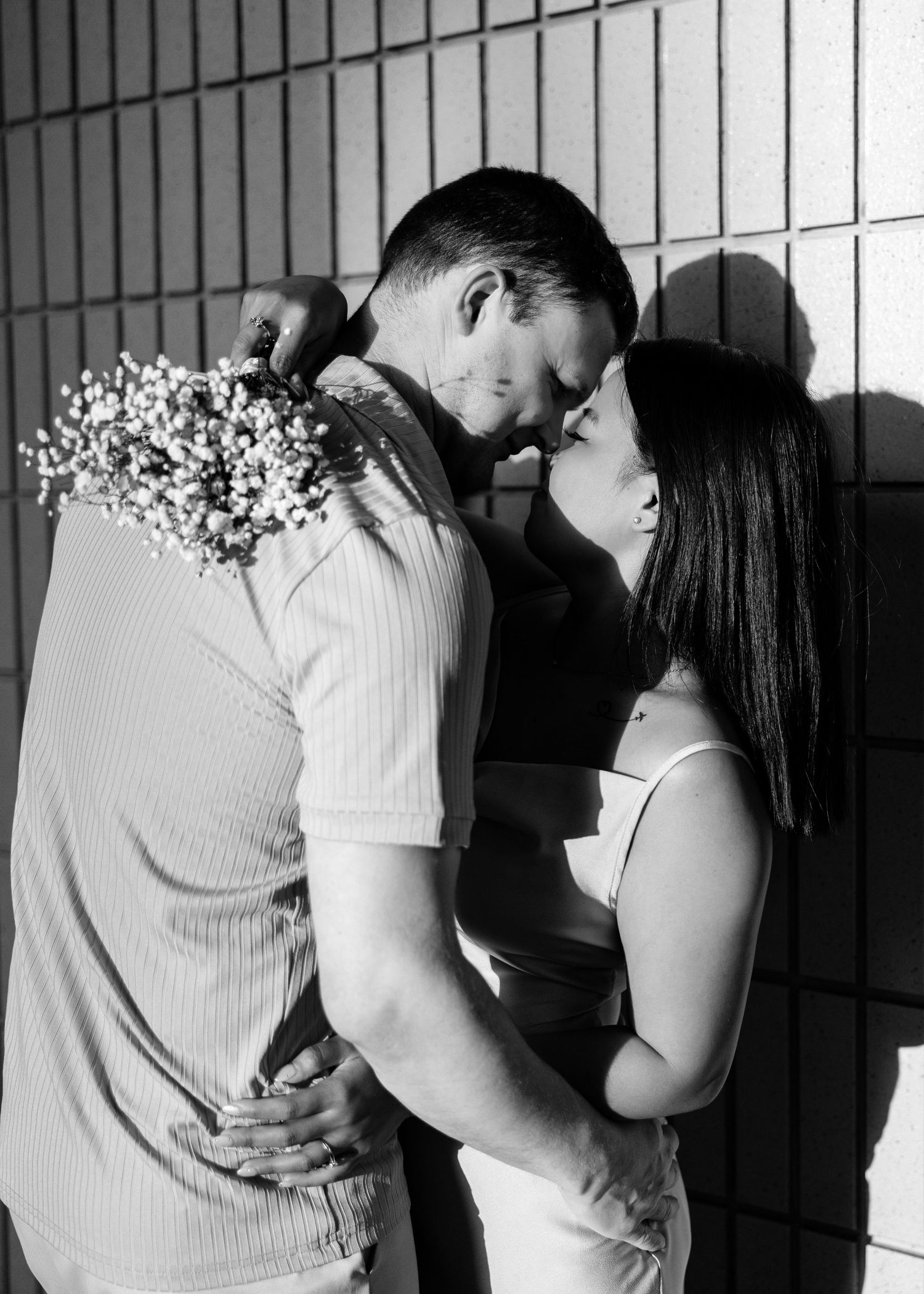 Couple sharing intimate romantic moment with four progressive panels showing them moving closer together in black and white. Couple Session
