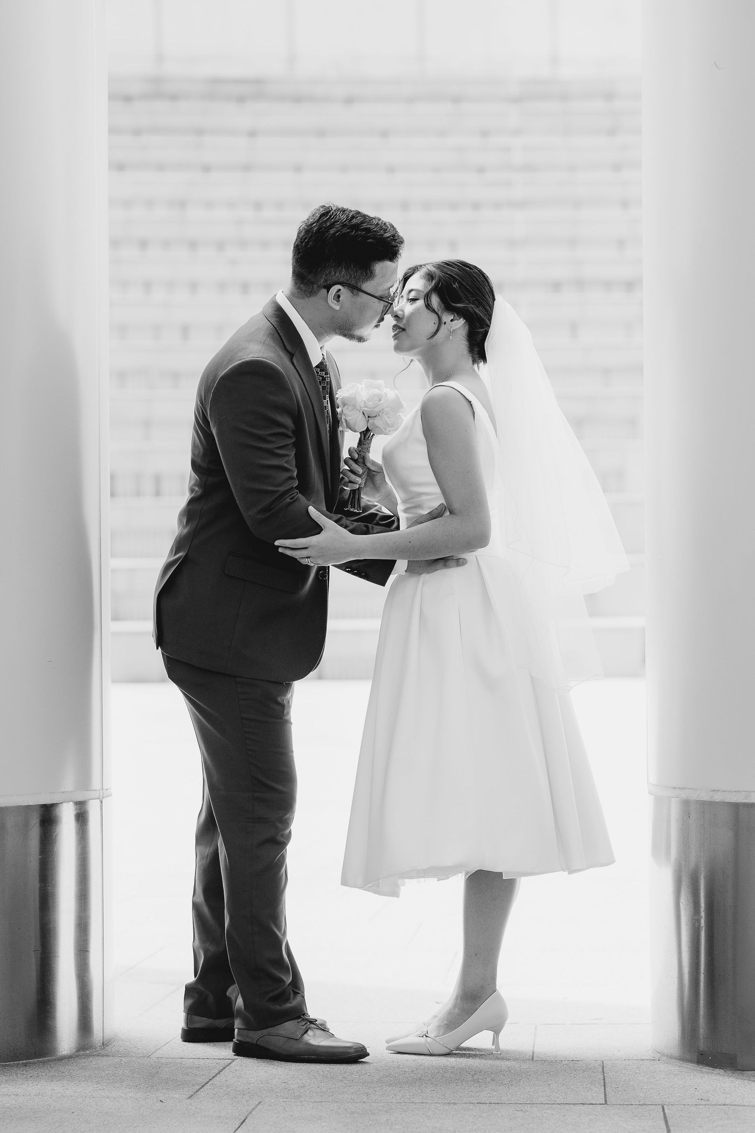 A romantic black and white photo sequence showing a couple in wedding attire exchanging a tender kiss. Civil Ceremony in Hong Kong