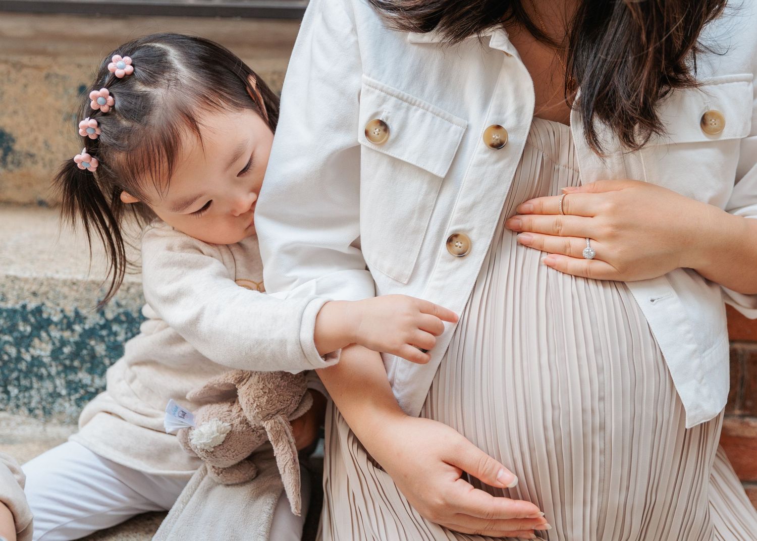 Pregnant woman photoshoot in white tones against a neutral background. Maternity Photoshoot in Hong Kong
