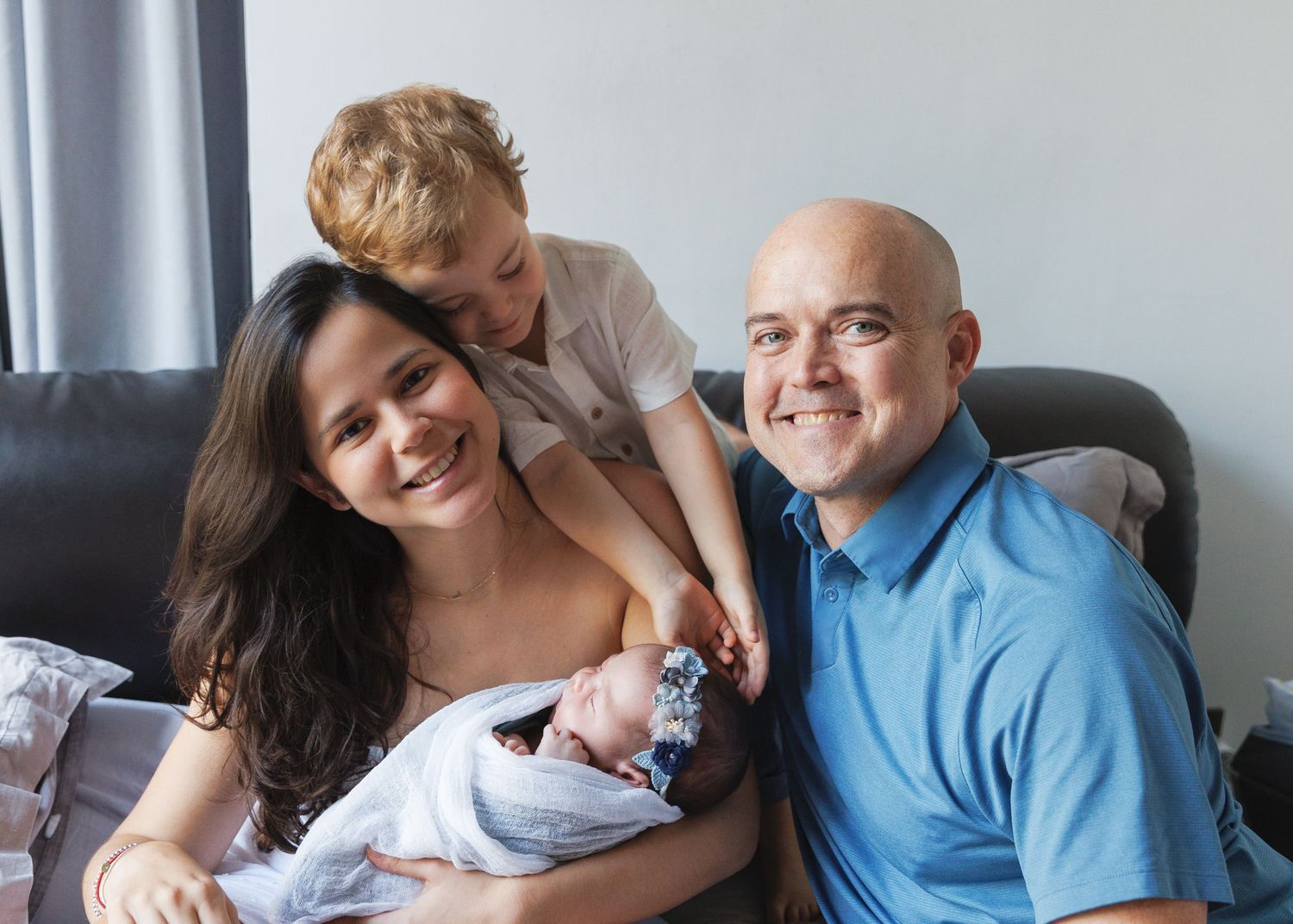 Happy couple relaxing on couch at home while having quality time together. Newborn Photographer in Hong Kong
