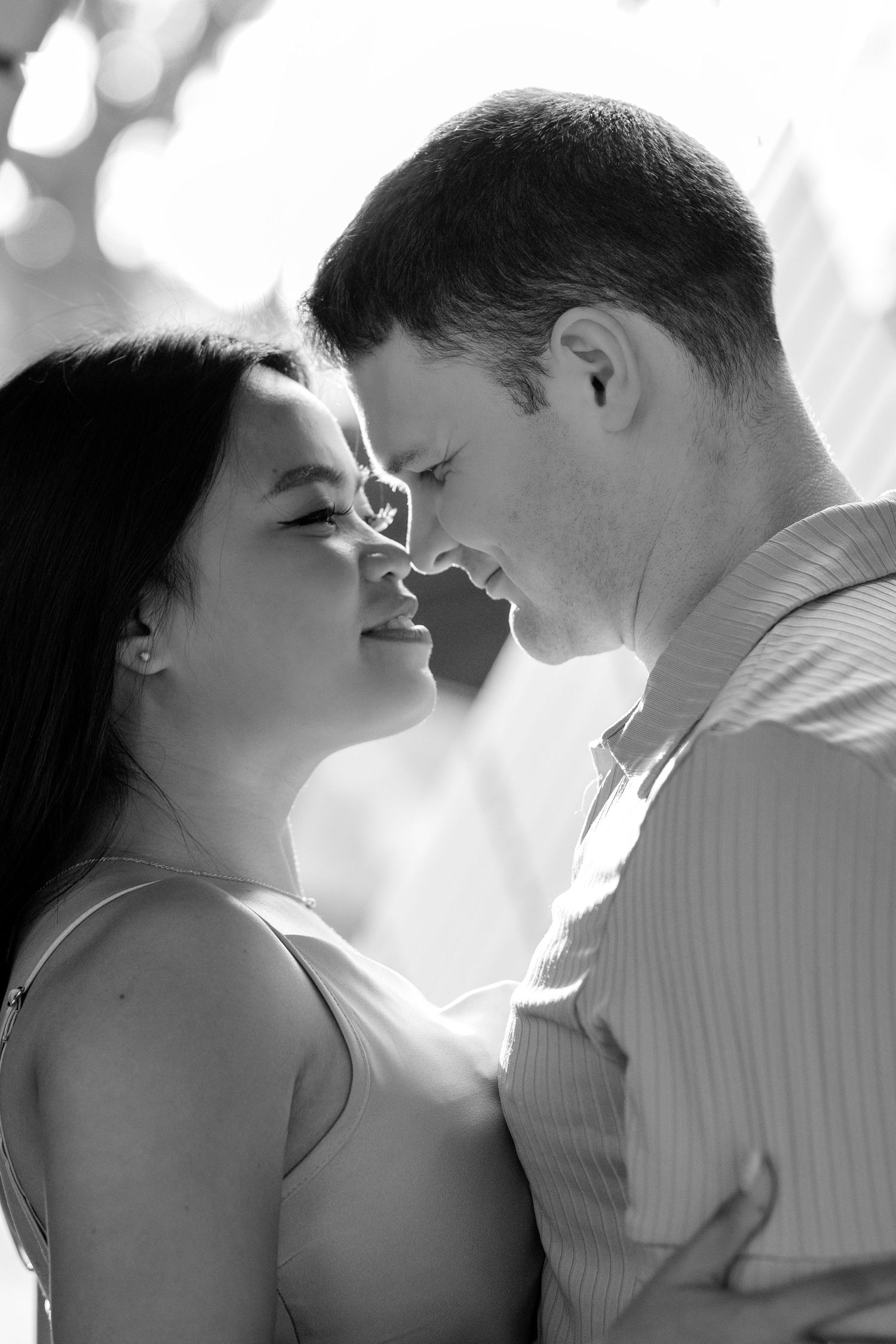 Black and white romantic portraits showing couple embracing and almost kissing in intimate close-up shots. Couple Session in Hong Kong