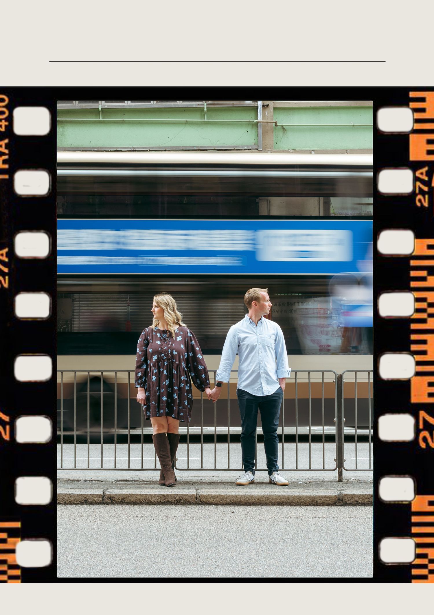Couple holding hands on urban street with blurred blue train passing behind them, styled as vintage film strip photo. couple session in HK