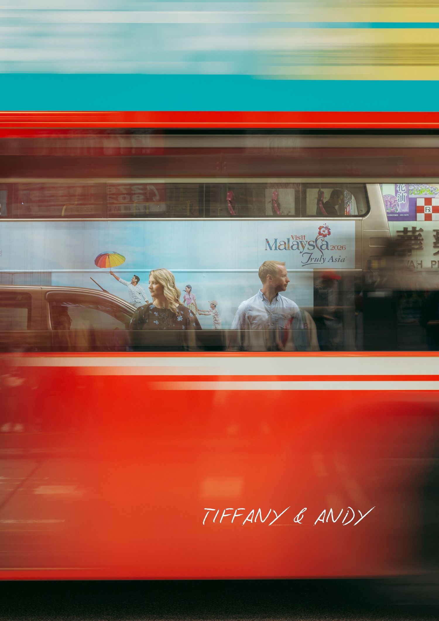 Blurred red London bus passes couple Tiffany and Andy standing on a busy city street. couple session in Hong Kong. Pre Wedding HK