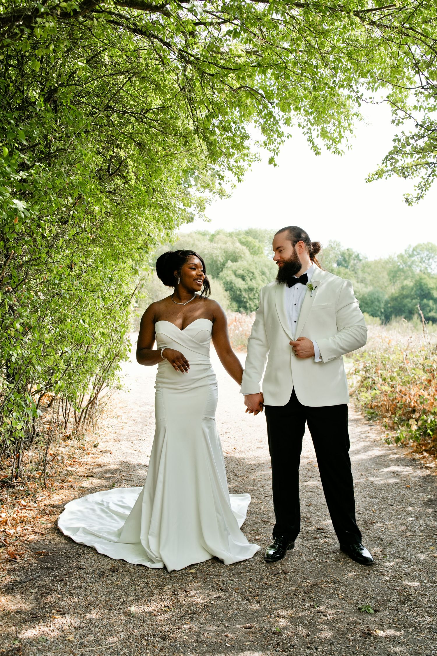 Adonis and Rachel together beneath the trees on their wedding day.