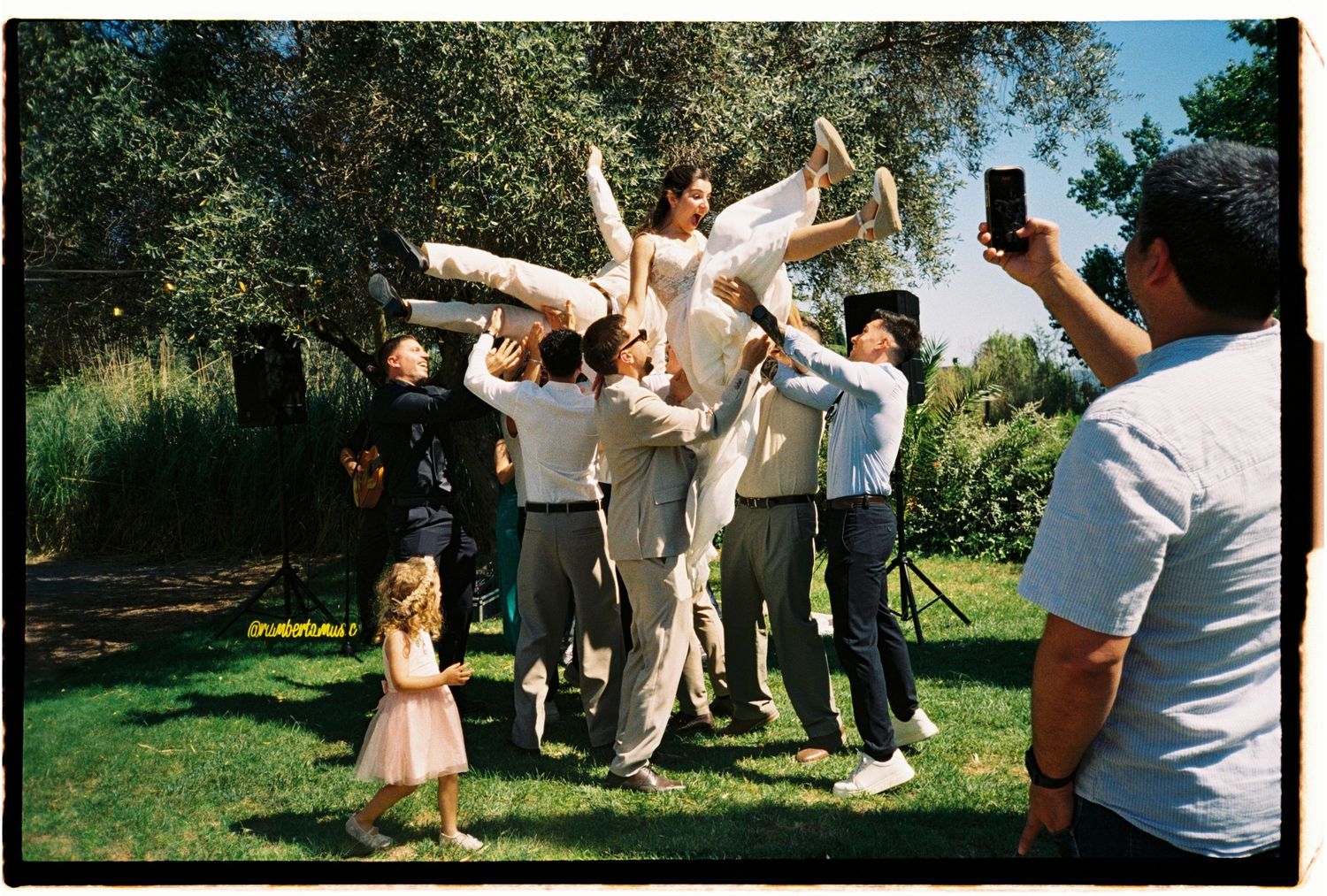 Wedding guests celebrating the newlyweds outdoors during a joyful Barcelona wedding.