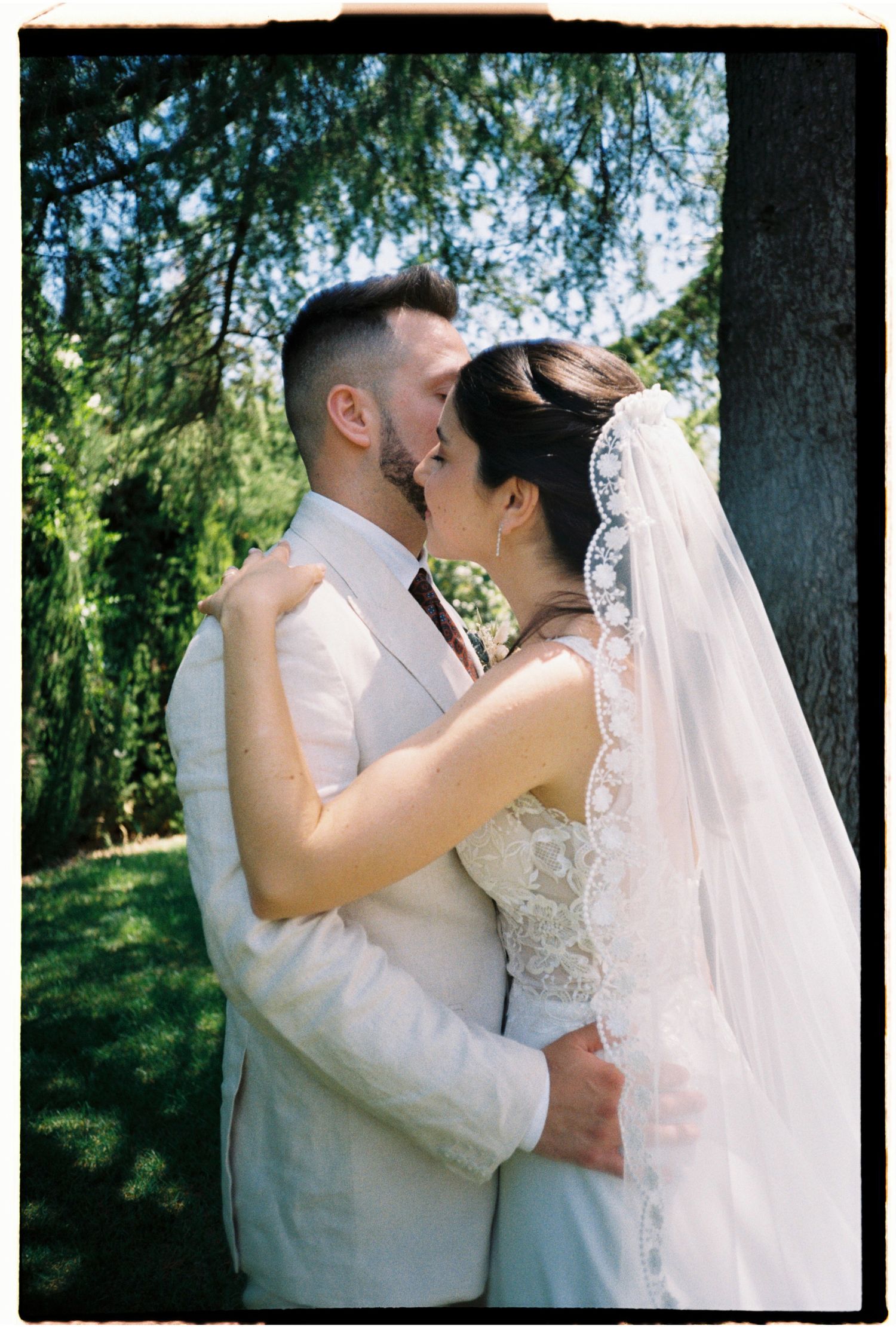 Bride and groom sharing an intimate moment outdoors on their wedding day in Barcelona, Spain.
