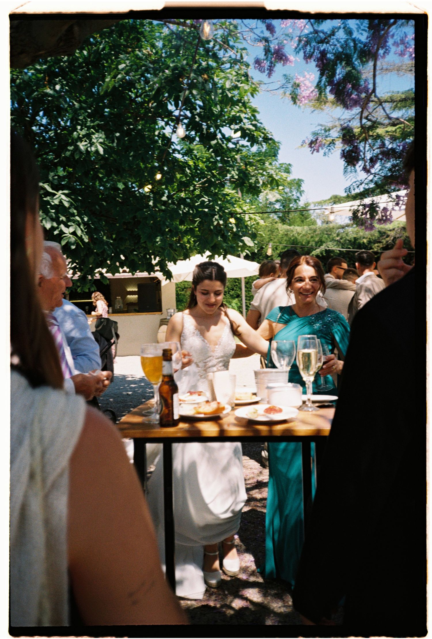 Wedding guests enjoying drinks and conversation during an outdoor summer reception in Barcelona.