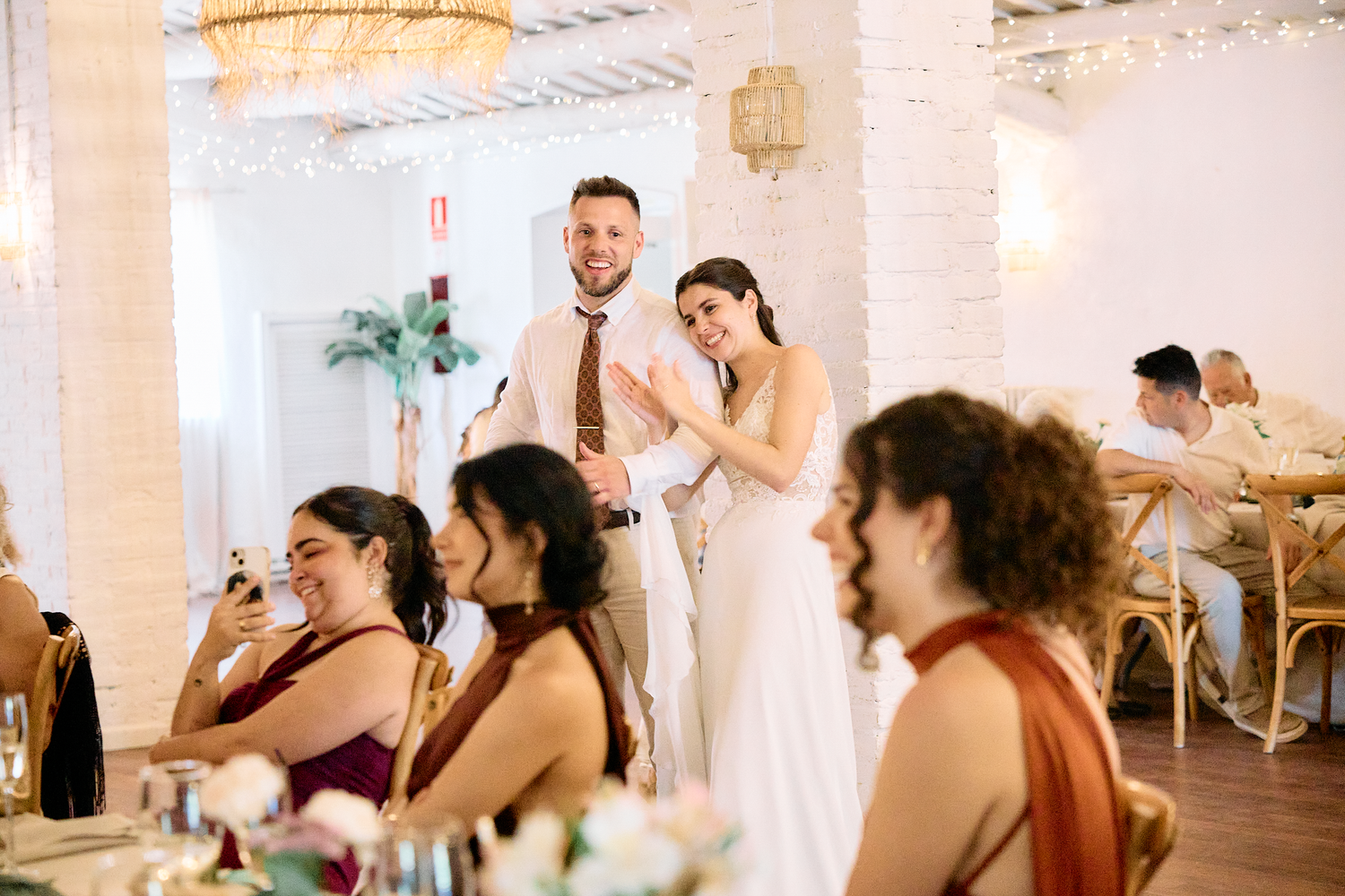 Bride and groom standing together during their intimate wedding reception in Barcelona, Spain.