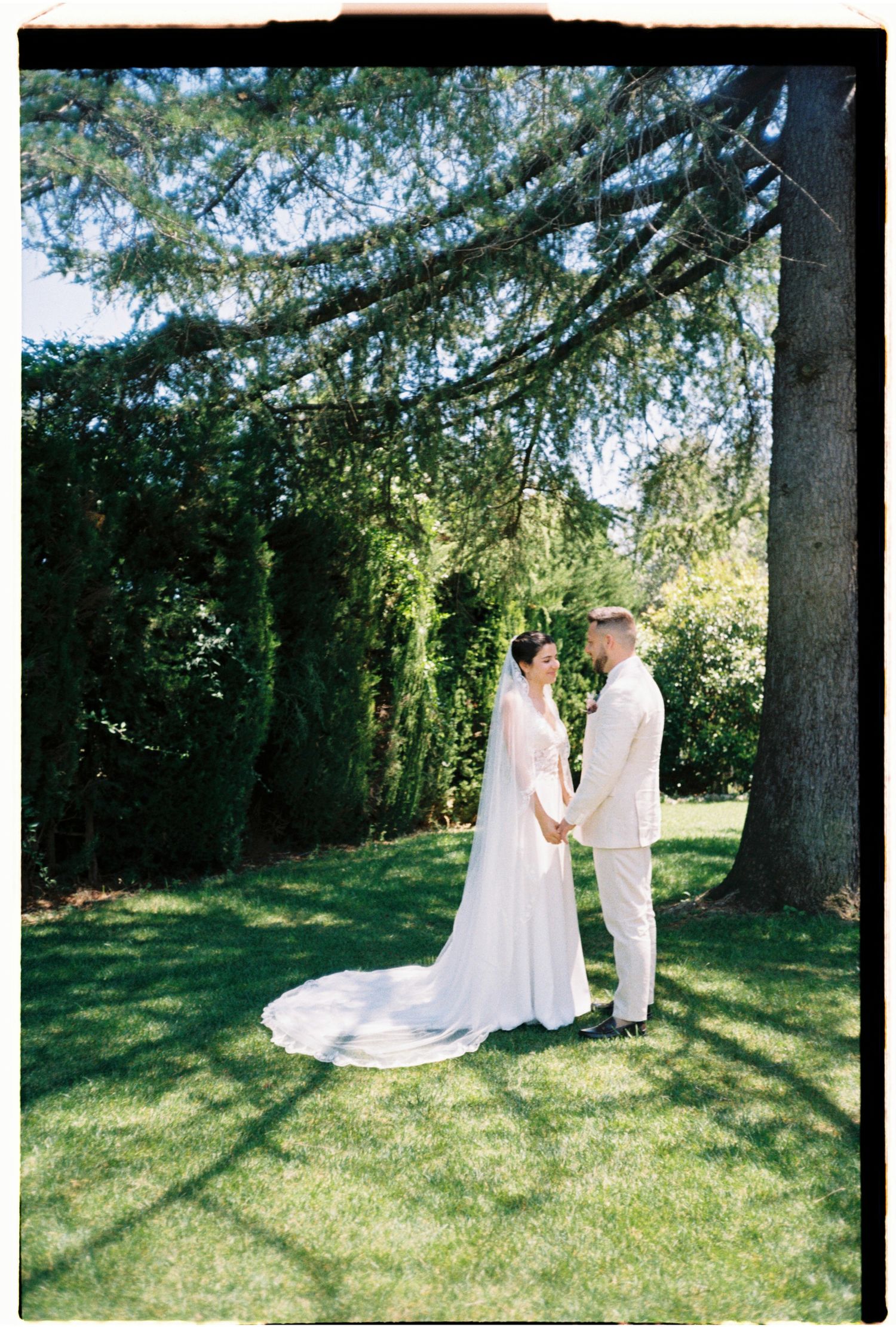 Bride and groom standing together beneath the trees during their intimate Barcelona wedding.
