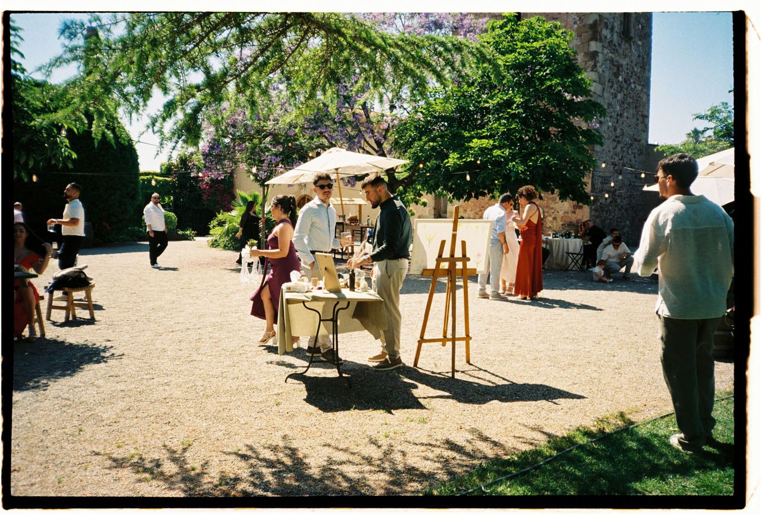 Film photograph of an intimate outdoor wedding ceremony surrounded by greenery in Barcelona.