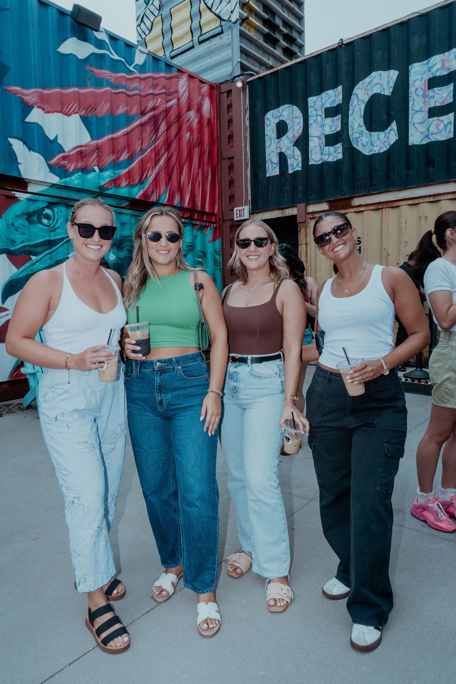 Group of friends posing together at outdoor summer party.