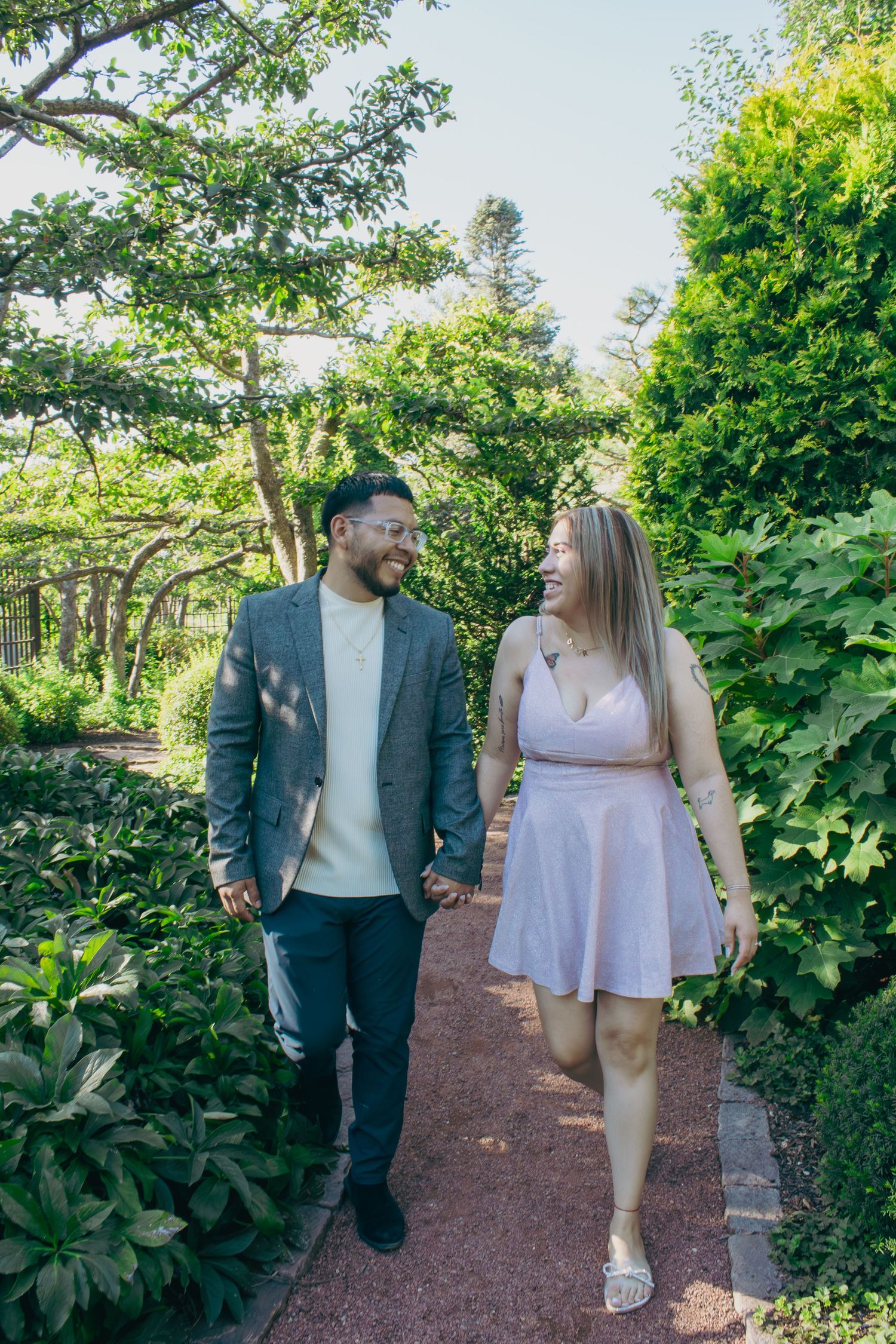 Happy couple walking and talking on a scenic garden trail.