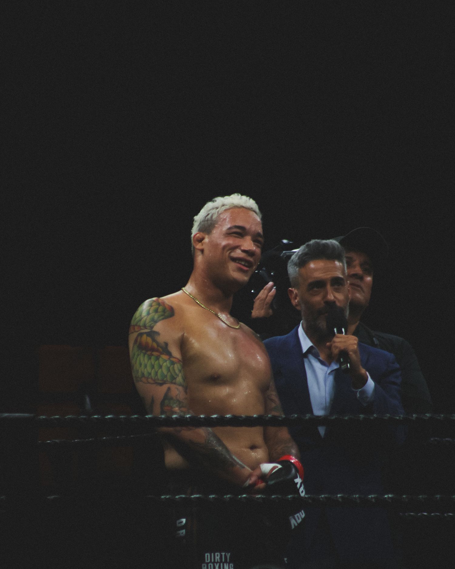 Two boxers engage in close combat during a professional fight.