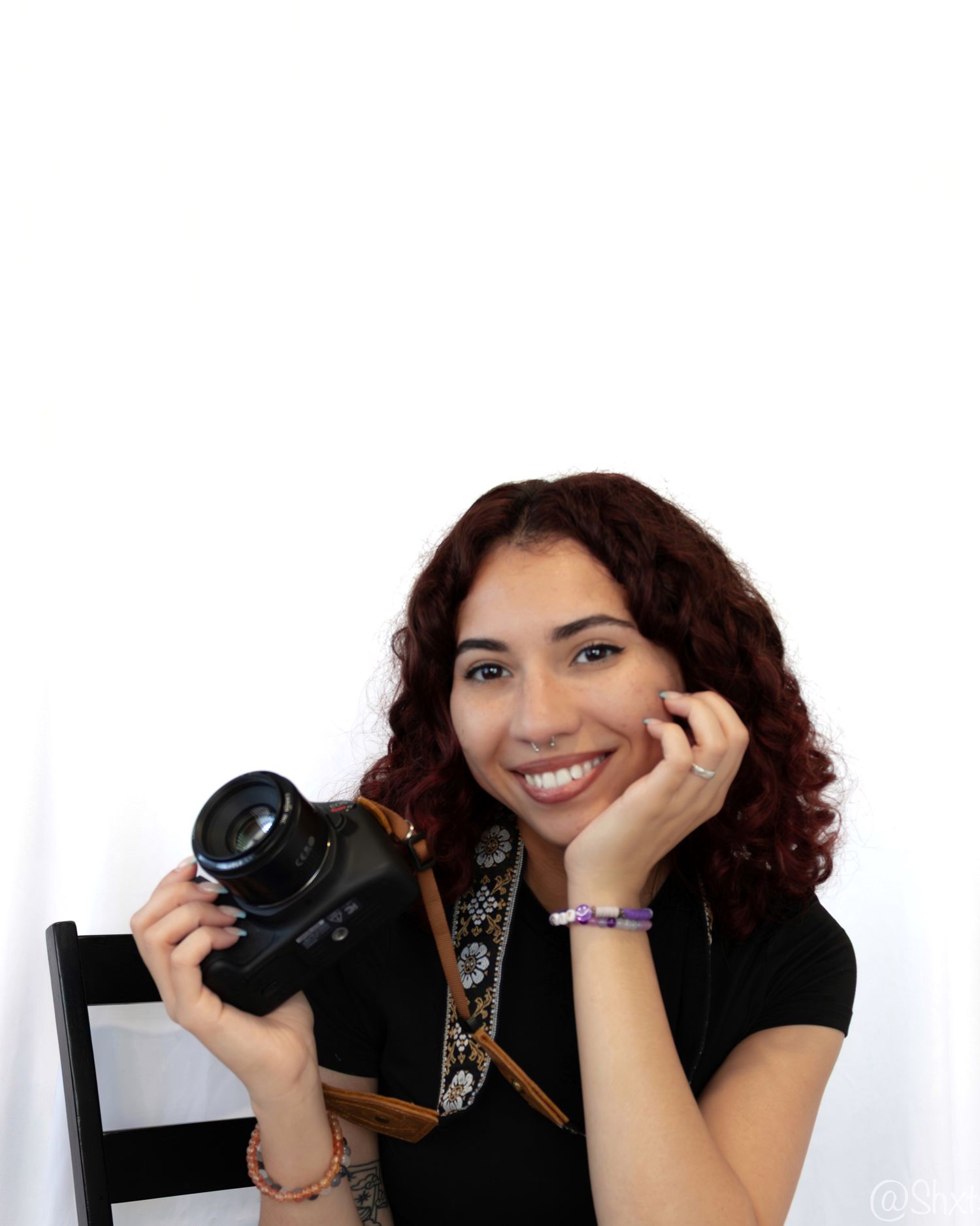 Portrait series of photographer with camera in various poses against white background.
Tiffany Leys