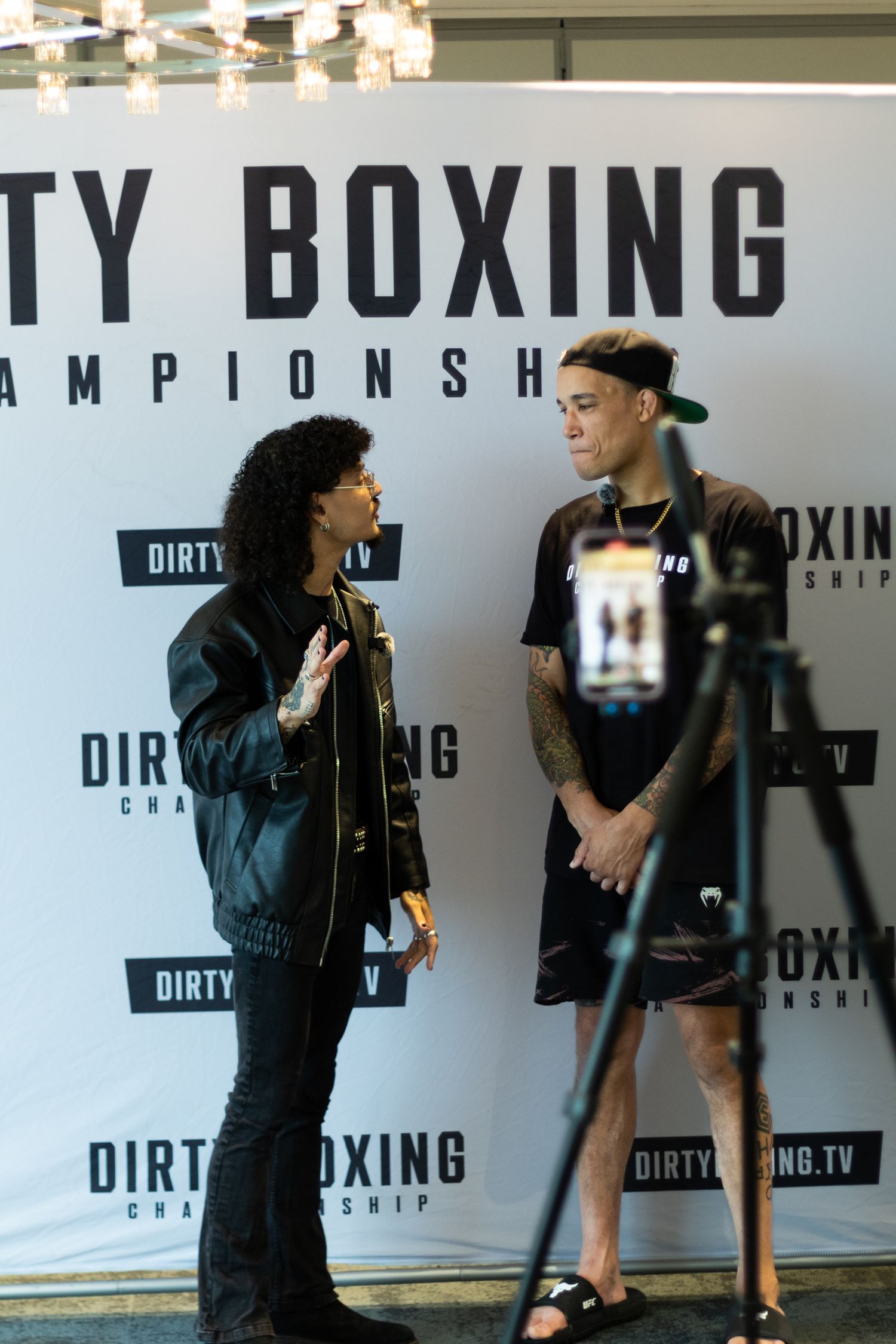 People interacting during interview session at Dirty Boxing Championship event.