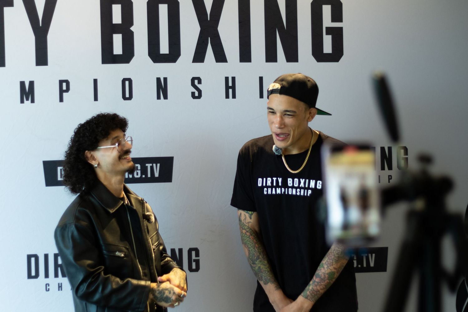 Multiple people gathered for interview session at boxing championship event.