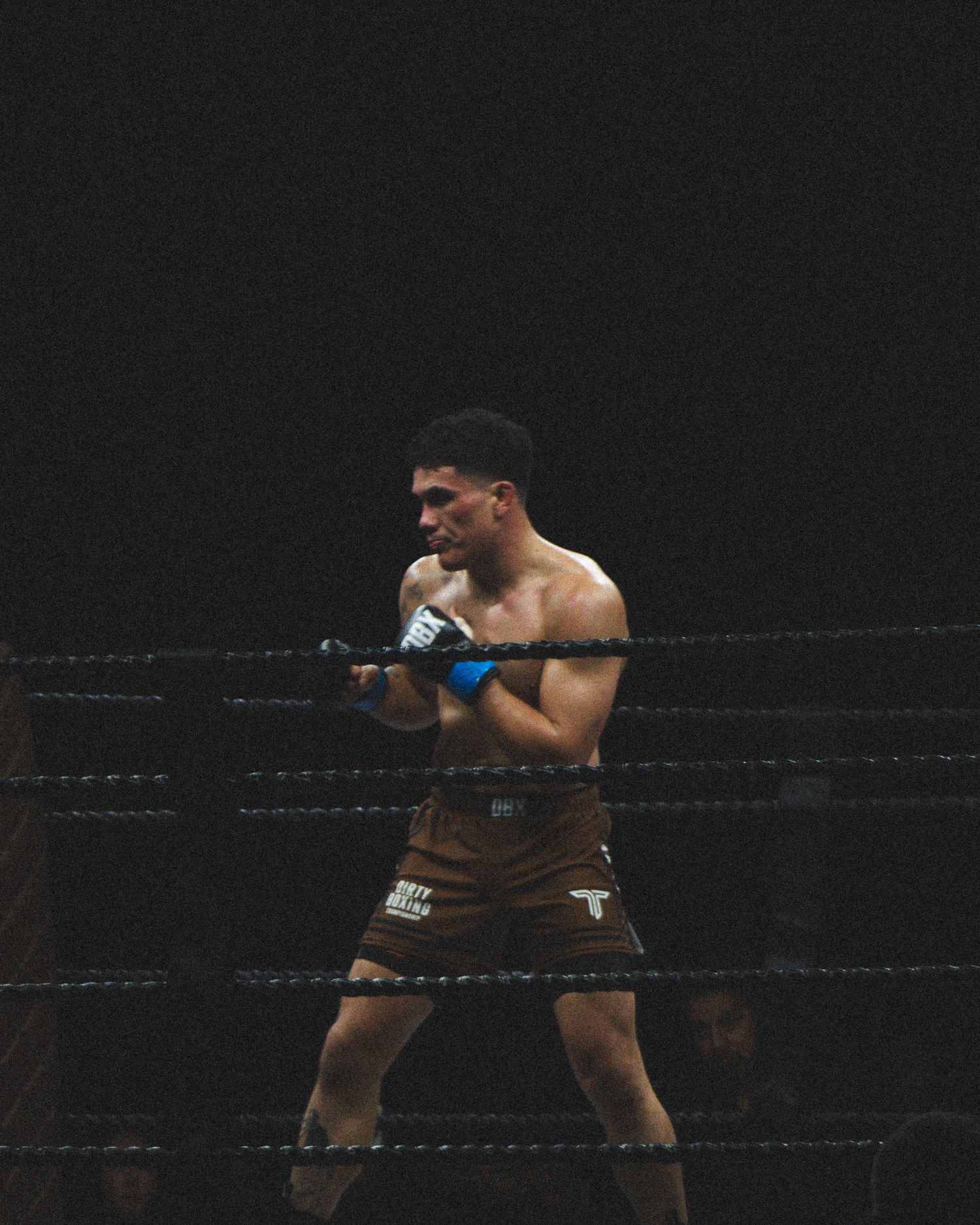 A boxer throws a powerful punch while maintaining defensive stance in the ring.