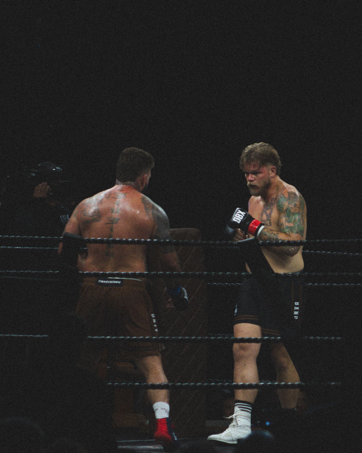 Boxers trade blows in an intense exchange during a professional fight.