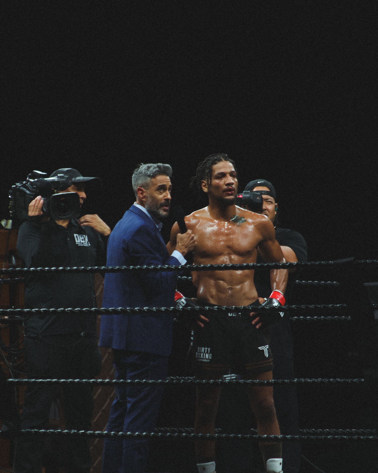 Two boxers engage in close combat during an intense professional match.